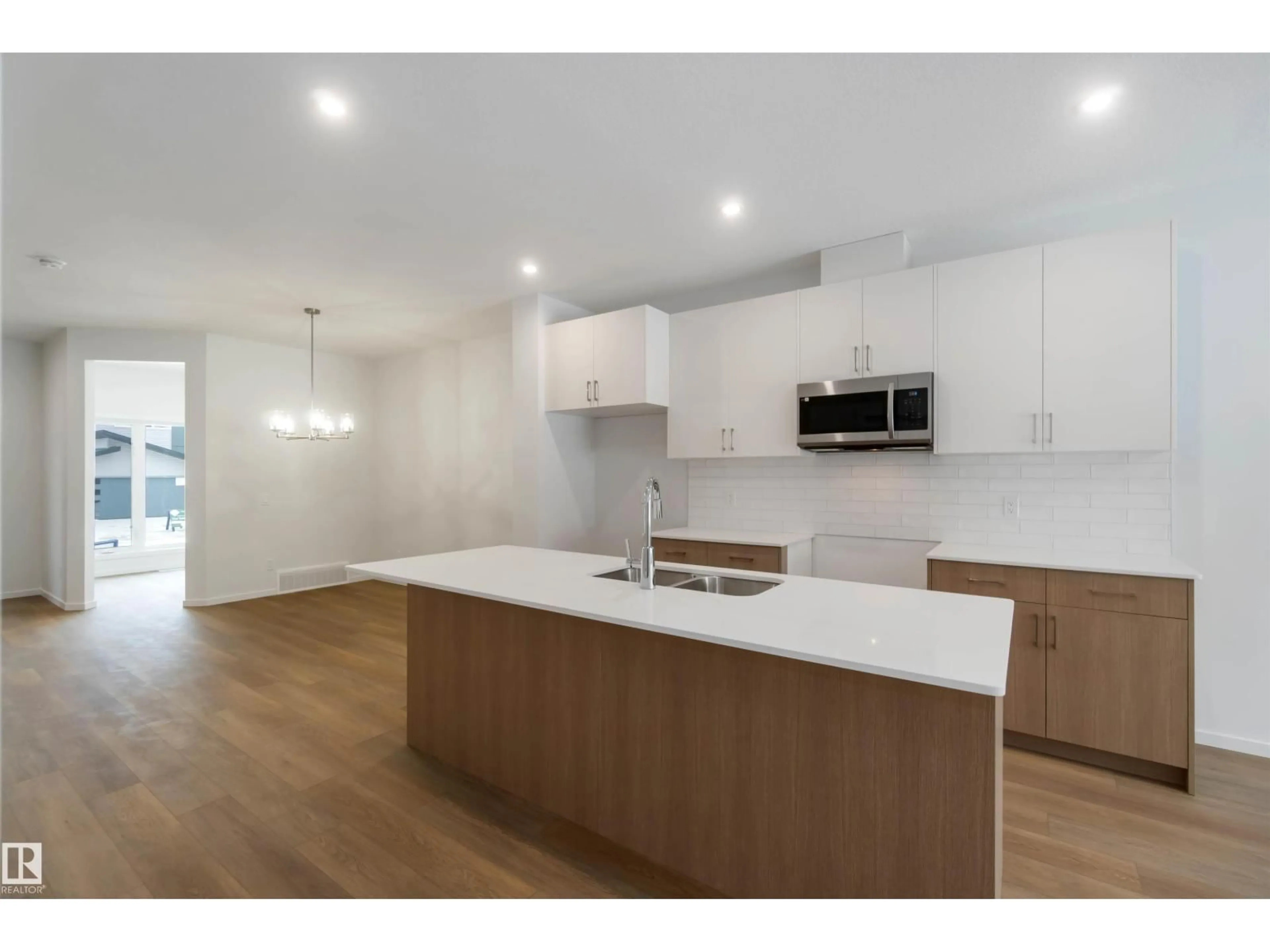 Open concept kitchen, wood/laminate floor for 18912 28 AV, Edmonton Alberta T6M3B1