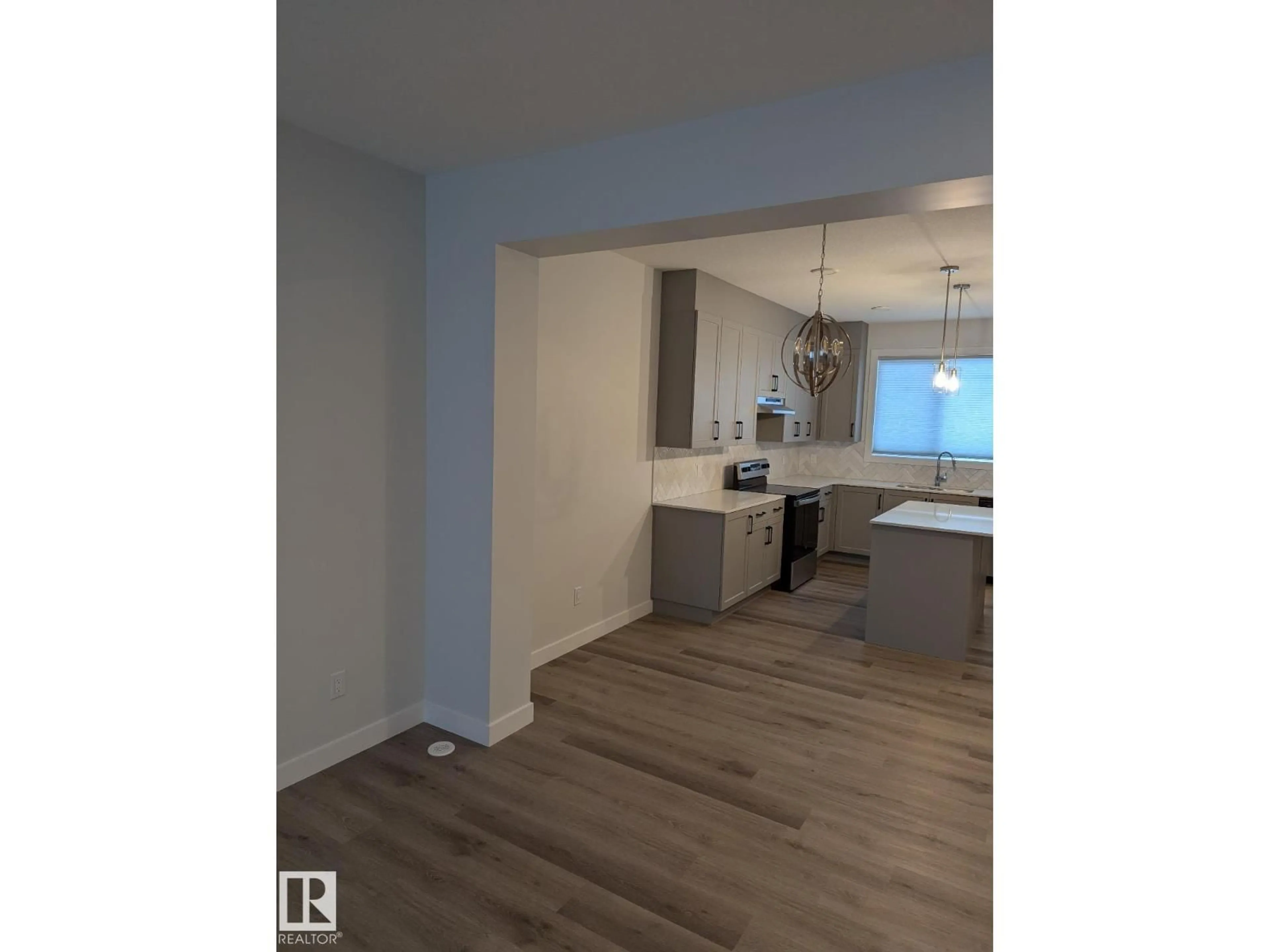 Open concept kitchen, wood/laminate floor for LI SW - 3520 KULAY LINK, Edmonton Alberta T6W5H3