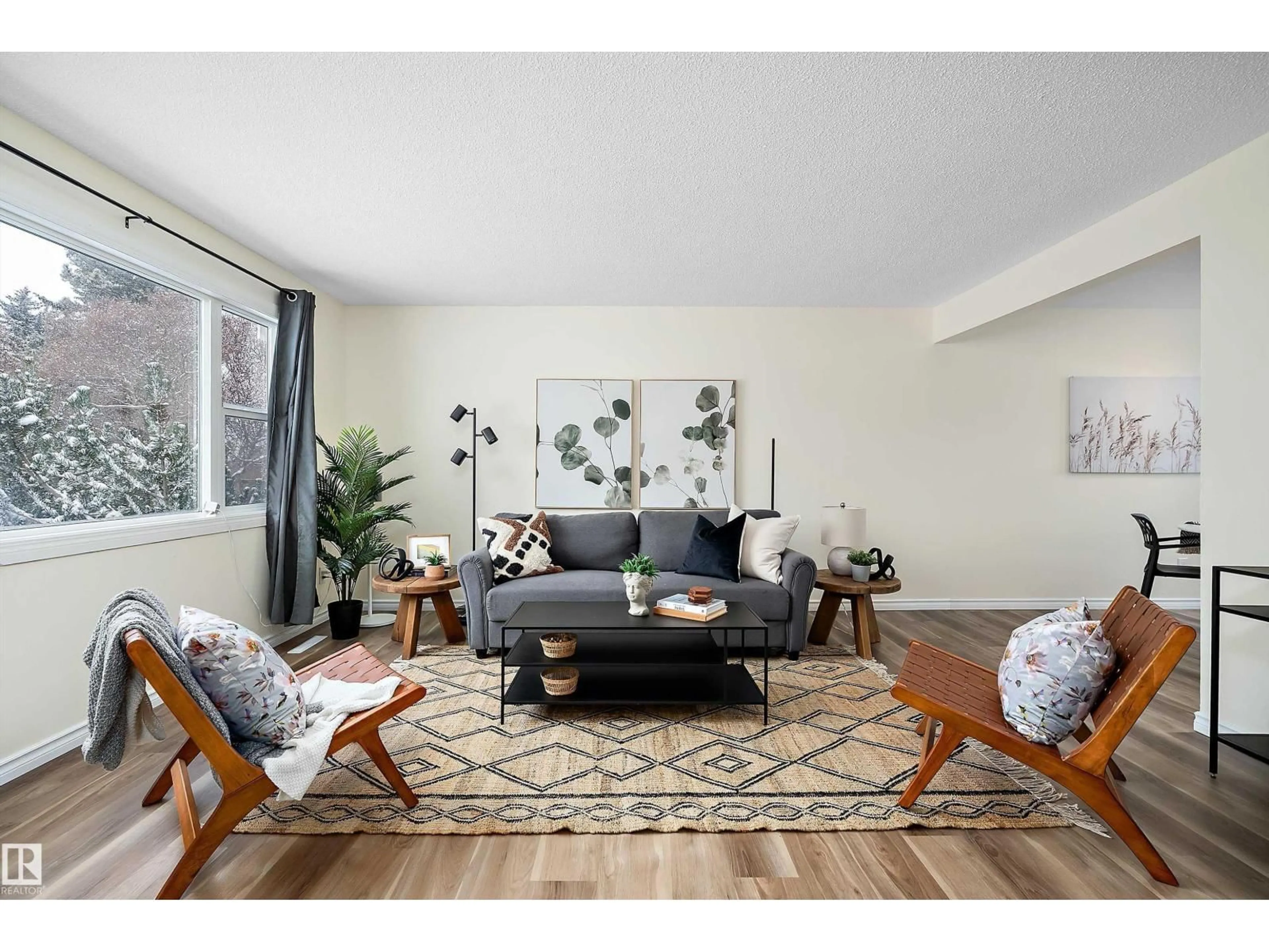 Living room with furniture, wood/laminate floor for 3207 107 AV NW, Edmonton Alberta T5W0C6