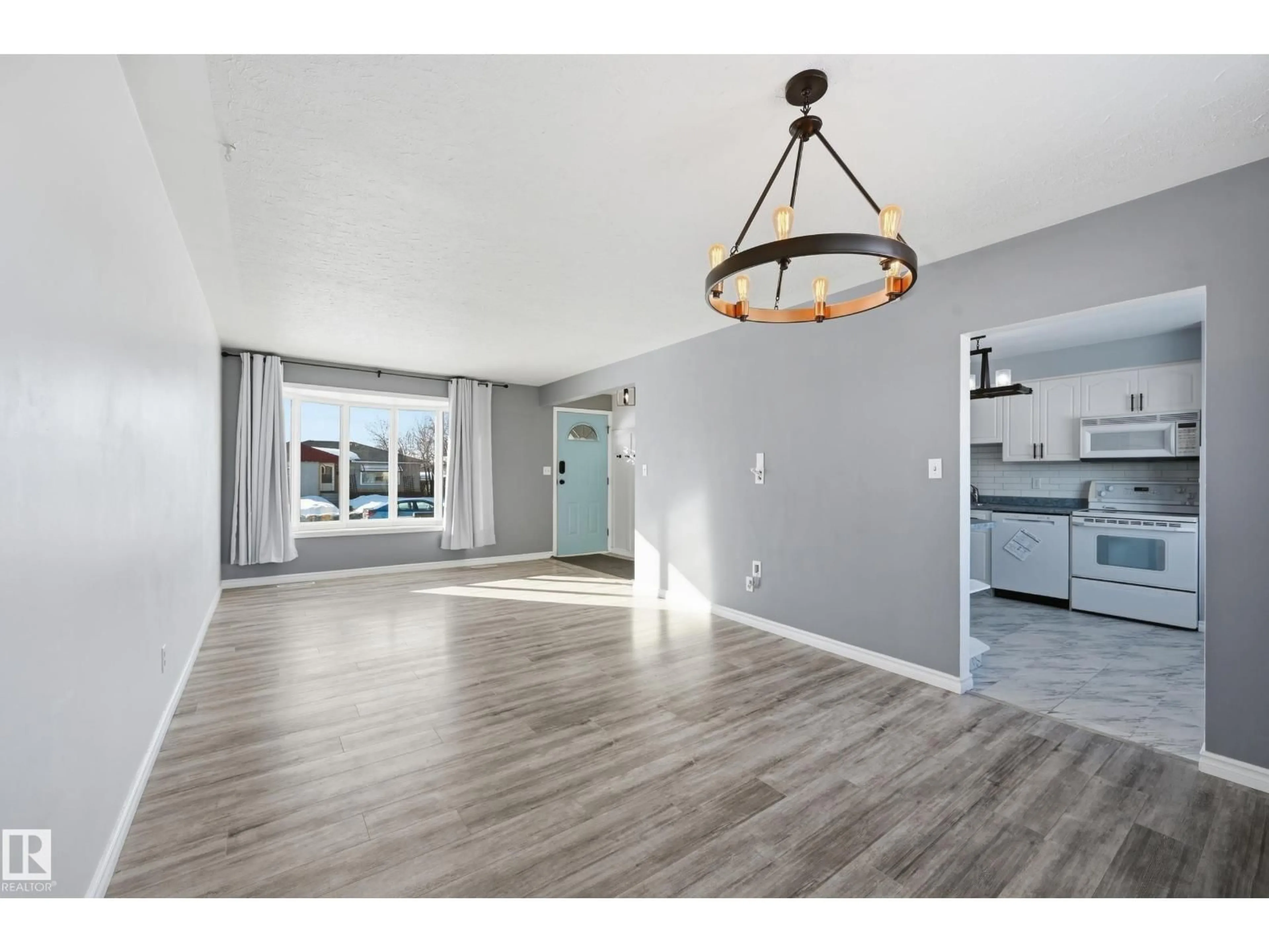 Open concept kitchen, wood/laminate floor for 13439 103 ST, Edmonton Alberta T5E4M7