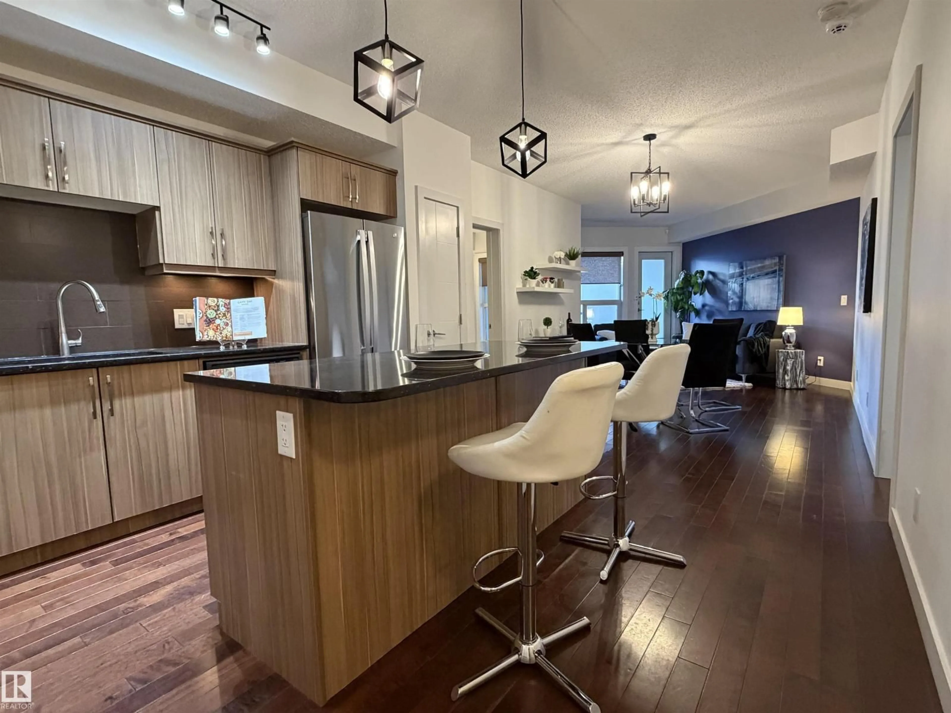 Open concept kitchen, wood/laminate floor for #115 - 10523 123 ST, Edmonton Alberta T5N1N9
