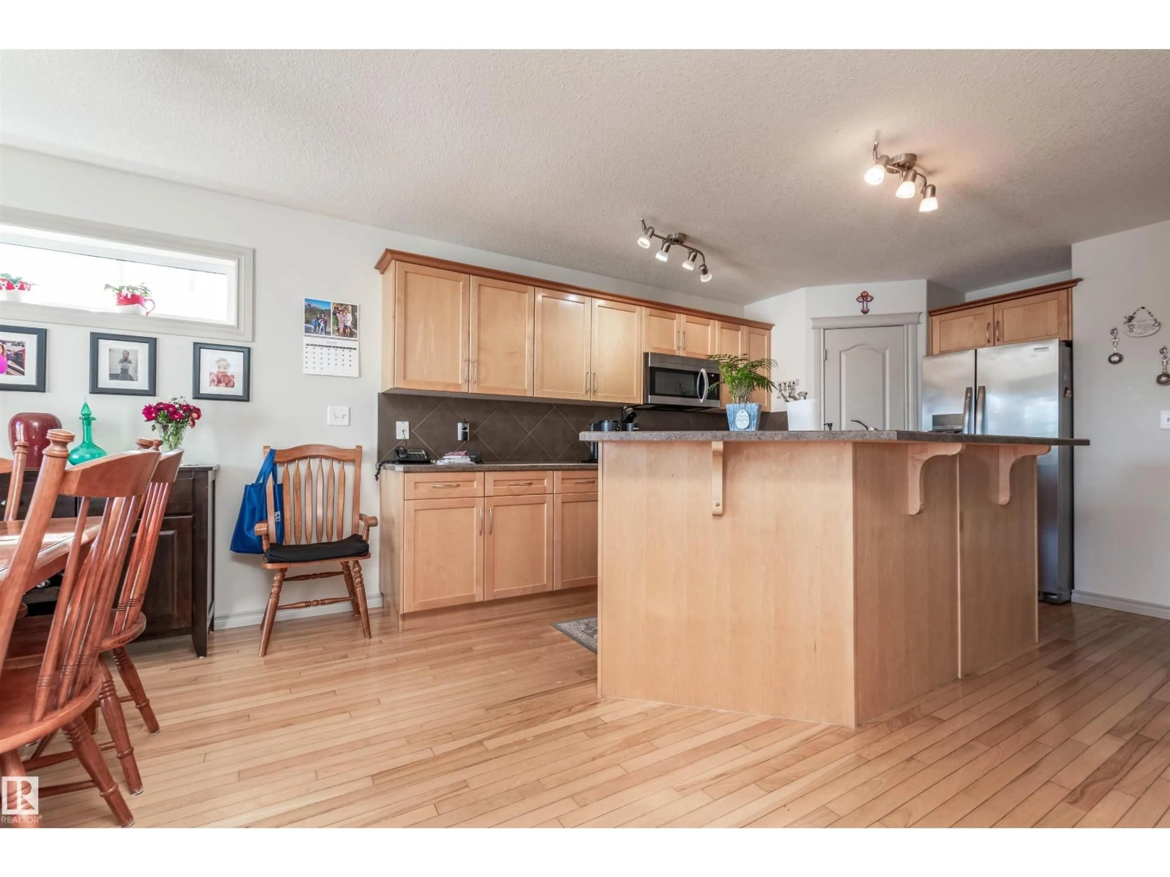 Open concept kitchen, wood/laminate floor for 143 CHATWIN RD, Sherwood Park Alberta T8H2S4