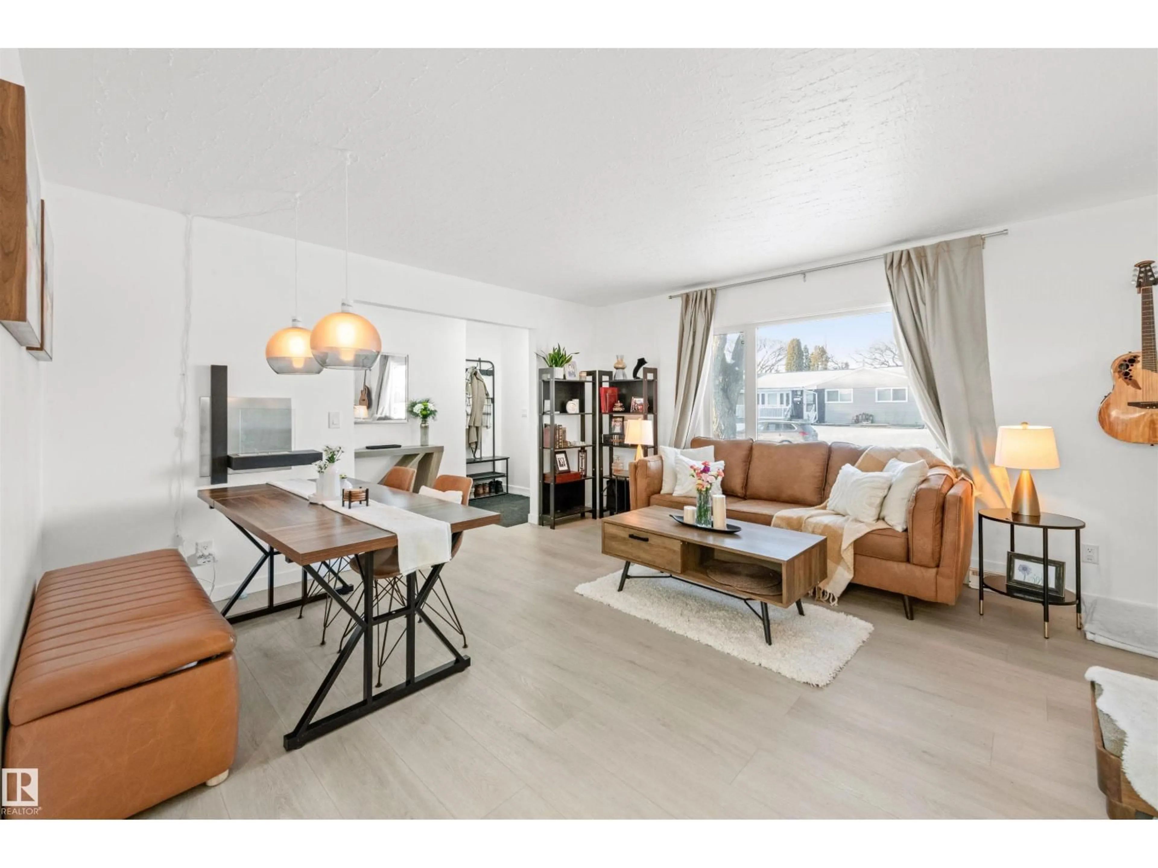 Living room with furniture, wood/laminate floor for NW - 3429 120 AV, Edmonton Alberta T5W1K1