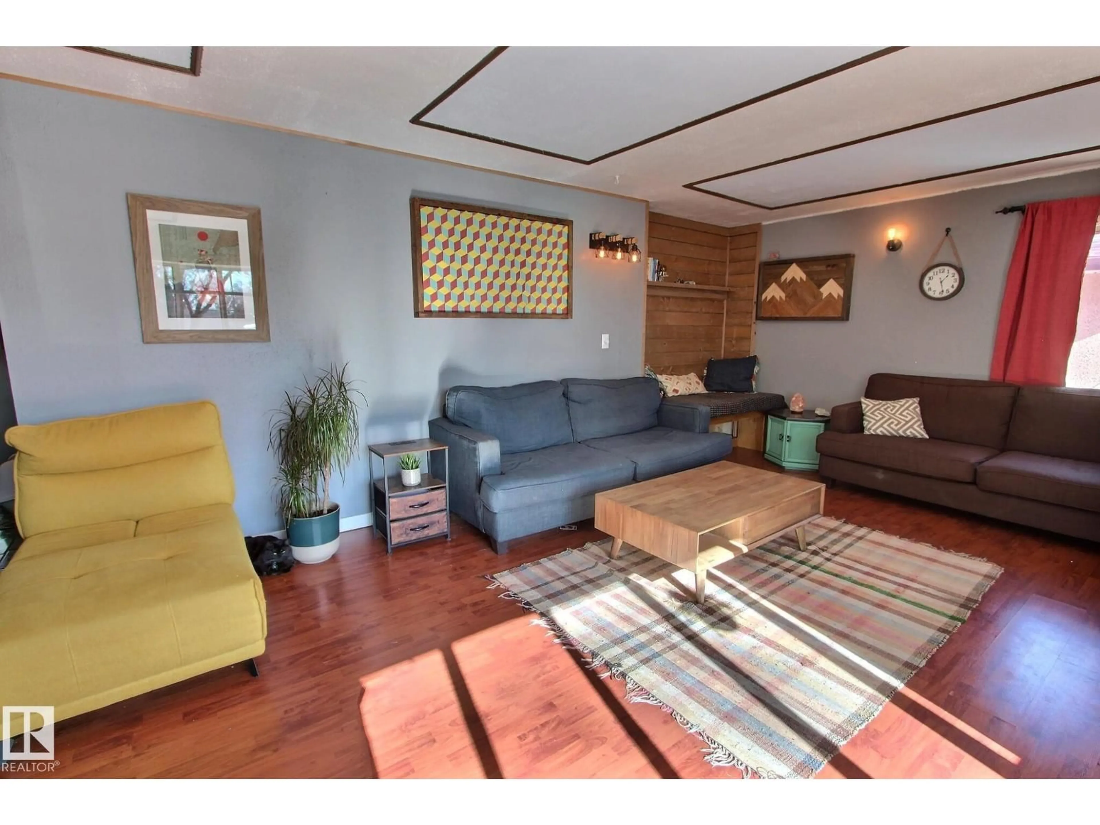 Living room with furniture, wood/laminate floor for 4422 116 AV, Edmonton Alberta T5W0X3