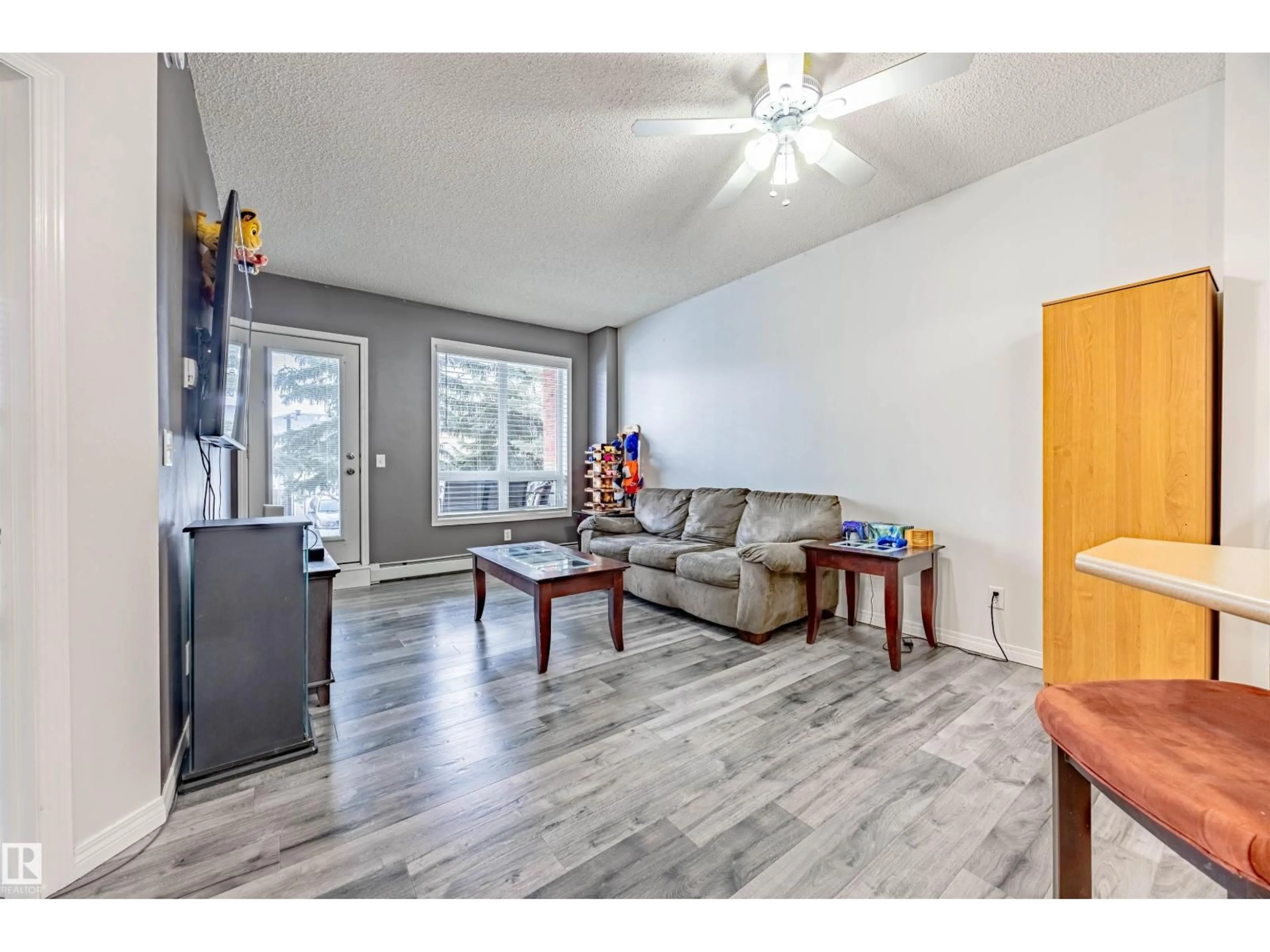 Living room with furniture, wood/laminate floor for 6220 - 132 134 AV, Edmonton Alberta T5A0A8