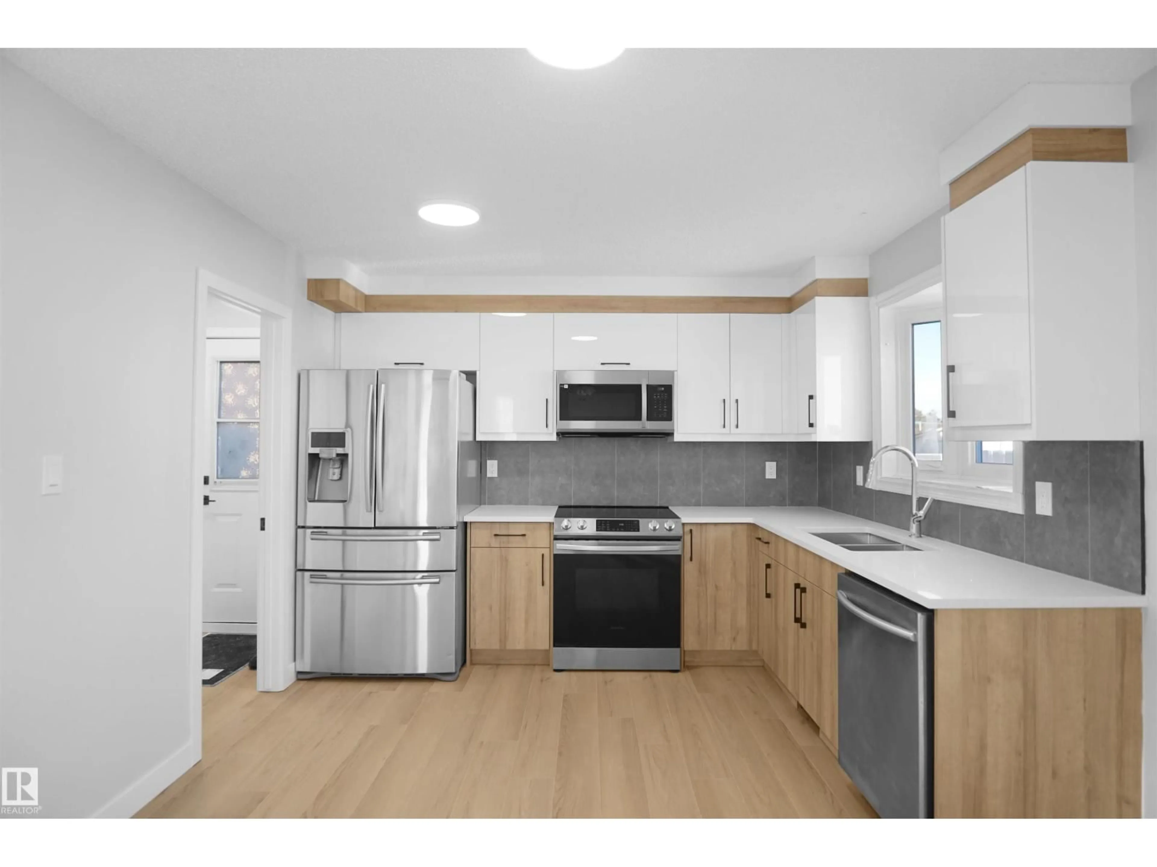 Open concept kitchen, wood/laminate floor for 3312 44A ST, Edmonton Alberta T6L4W9