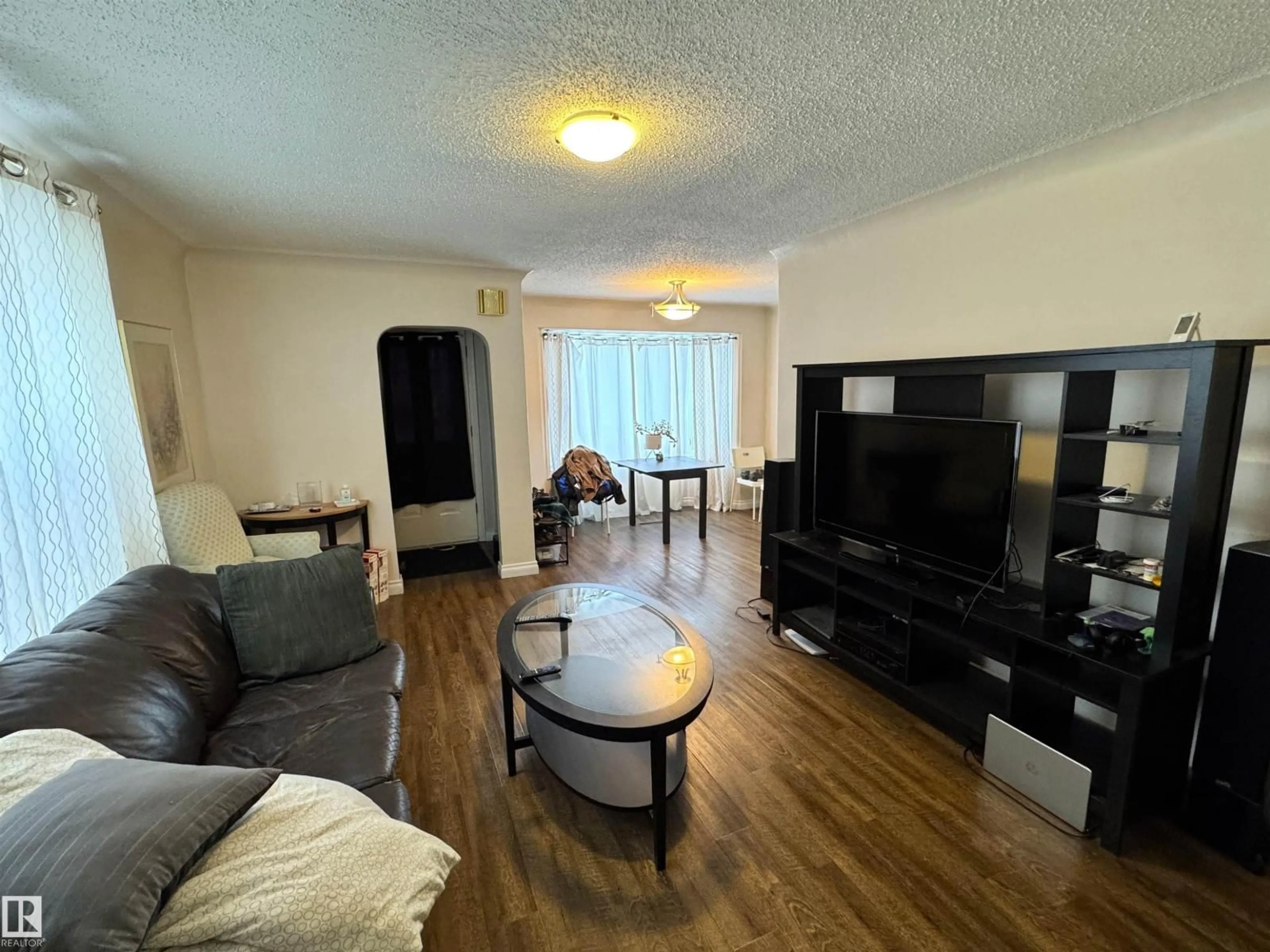 Living room with furniture, wood/laminate floor for 9015 91 ST, Edmonton Alberta T6C3N6