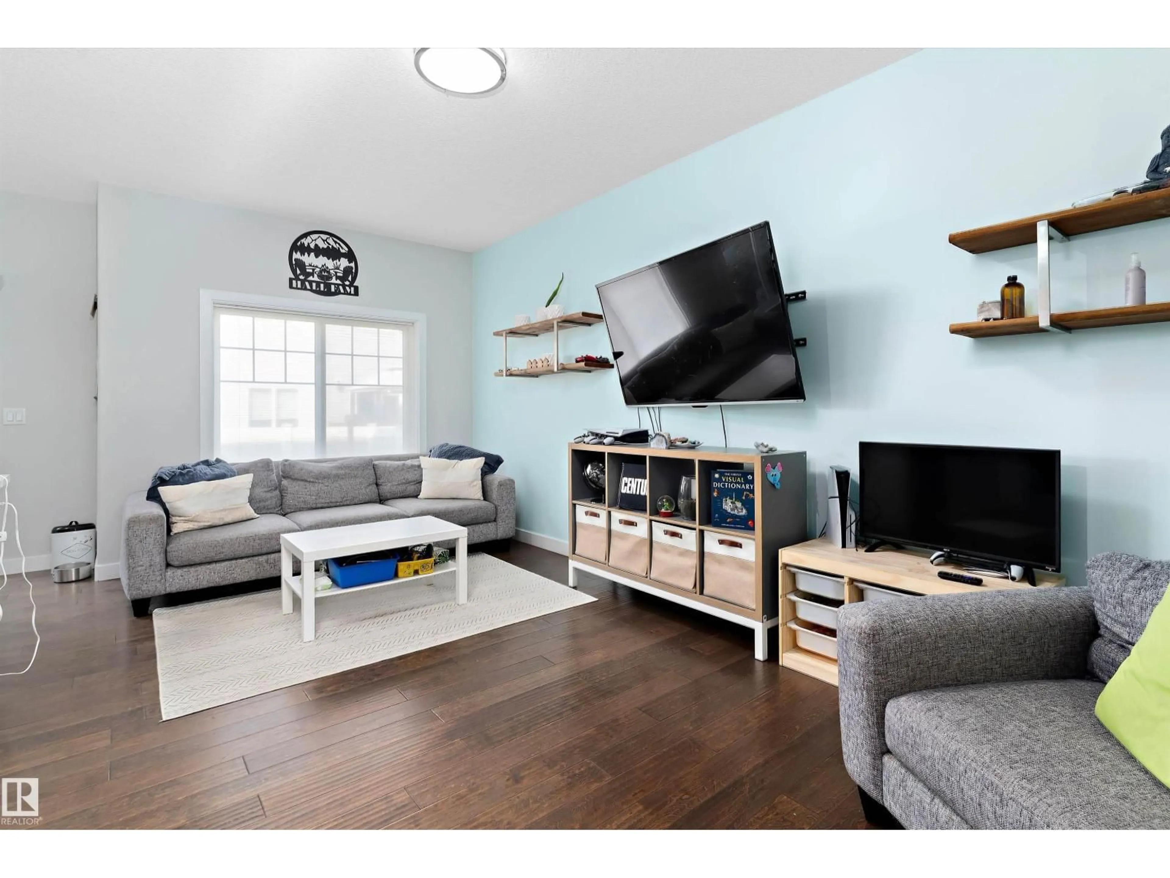 Living room with furniture, wood/laminate floor for 3304 66 ST, Beaumont Alberta T4X0W7