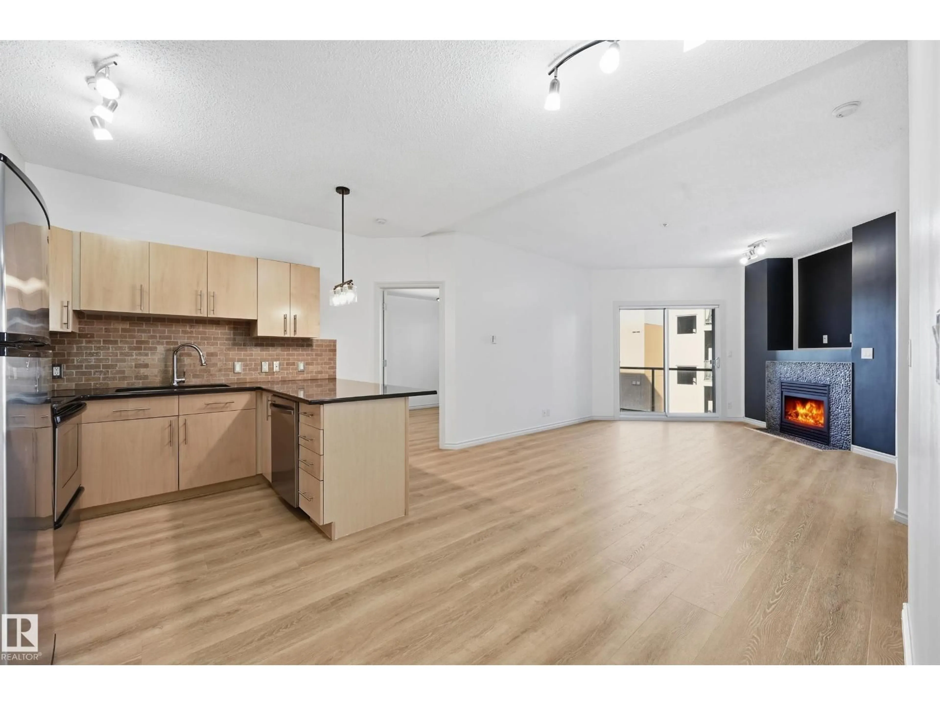 Open concept kitchen, wood/laminate floor for 517 - 10235 112 ST NW, Edmonton Alberta T5K1M7