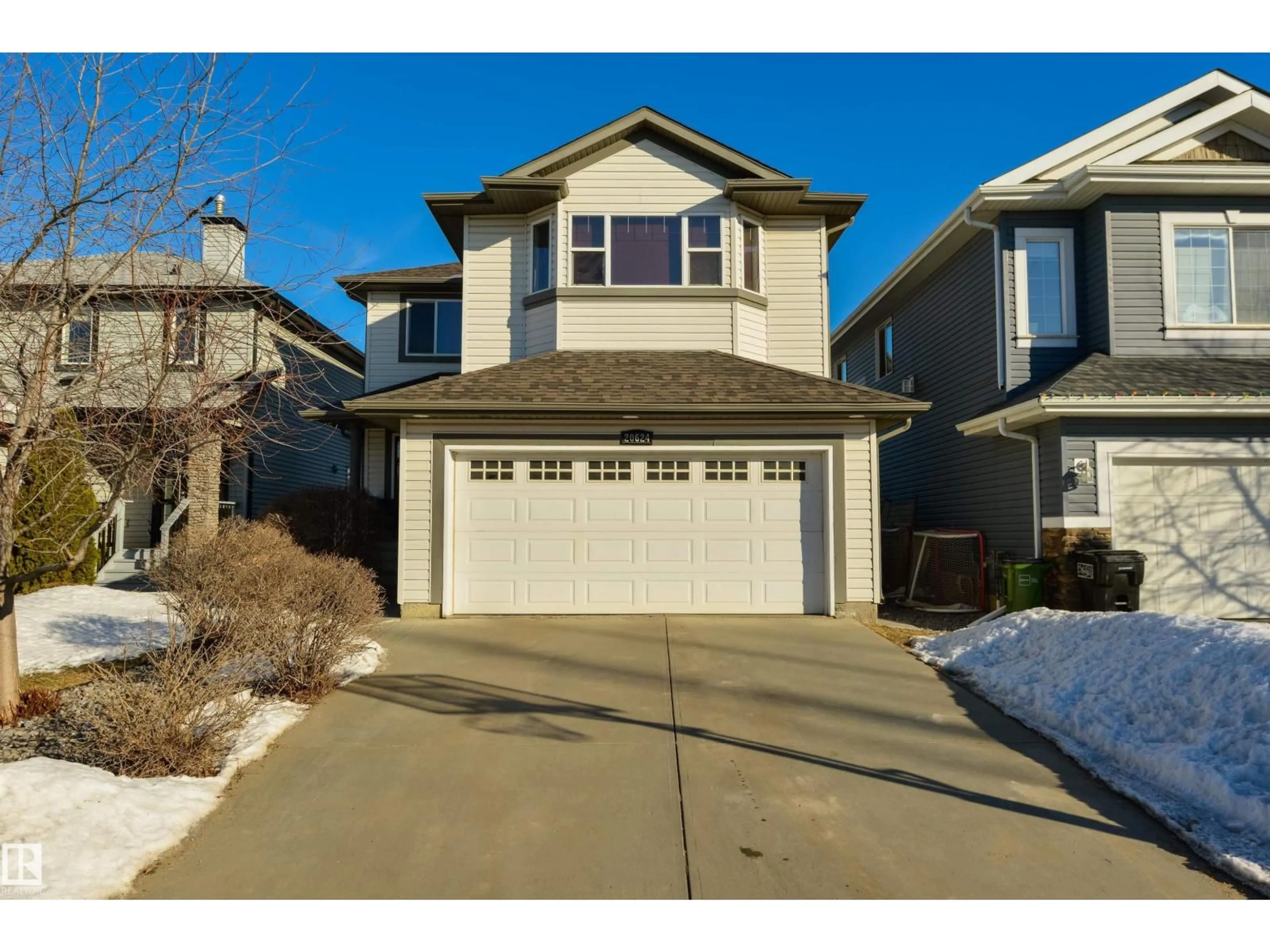 Home with vinyl exterior material, street for 20624 92 AV NW, Edmonton Alberta T5T1S9