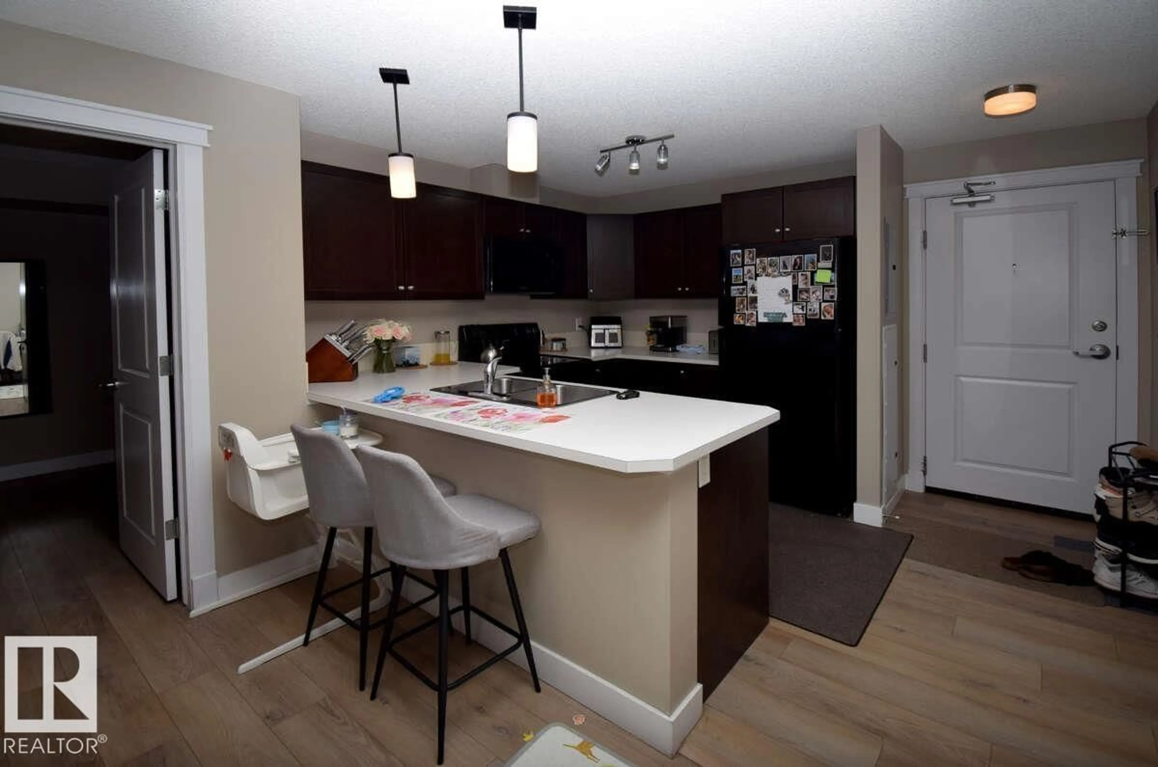 Open concept kitchen, wood/laminate floor for #218 - 3715 WHITELAW LN, Edmonton Alberta T6W2C3