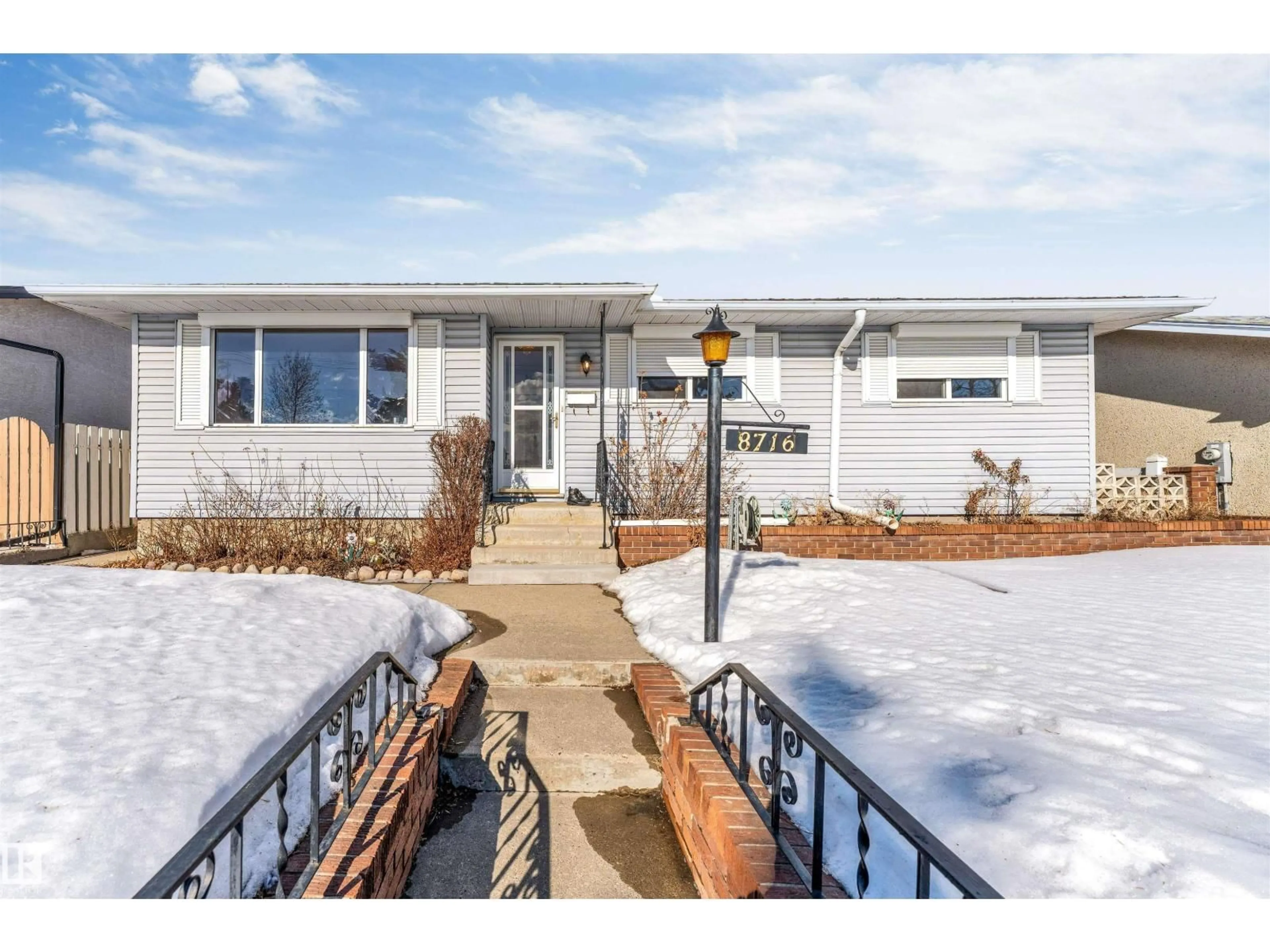 Home with vinyl exterior material, street for NW - 8716 137 AV, Edmonton Alberta T5E1Y4