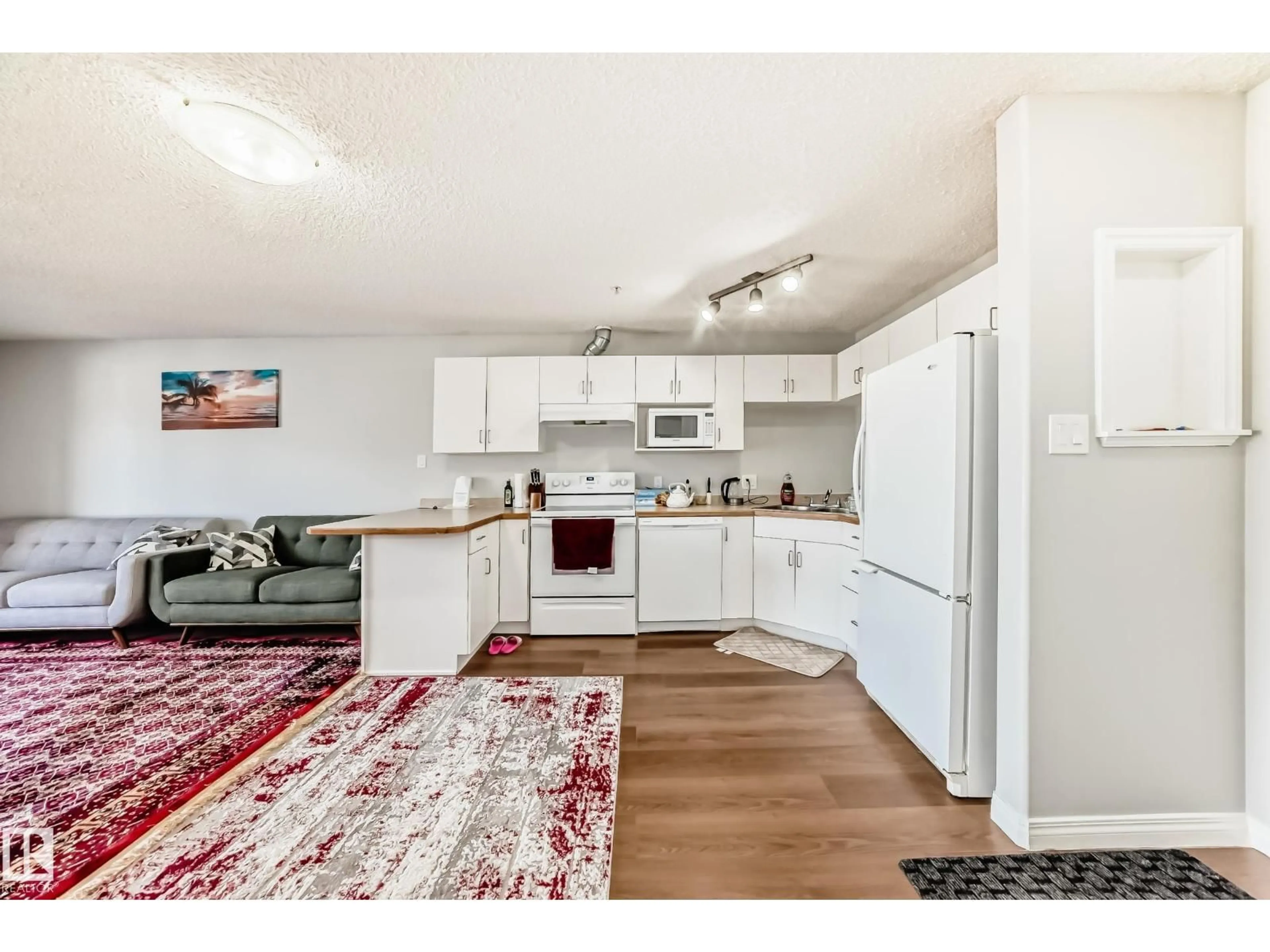 Open concept kitchen, wood/laminate floor for 427 11325 83 ST NW, Edmonton Alberta T5B4W5