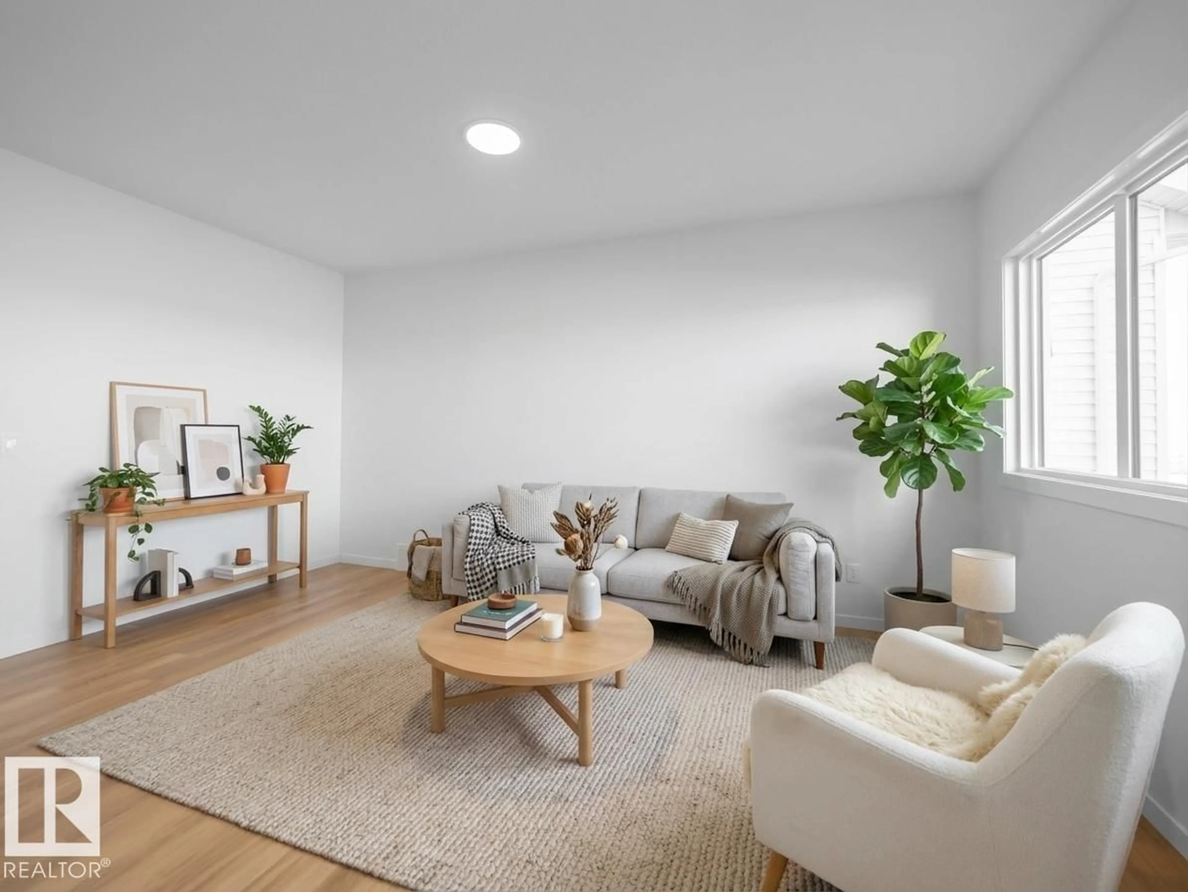 Living room with furniture, wood/laminate floor for NW - 19422 22A AV, Edmonton Alberta T6M3J2