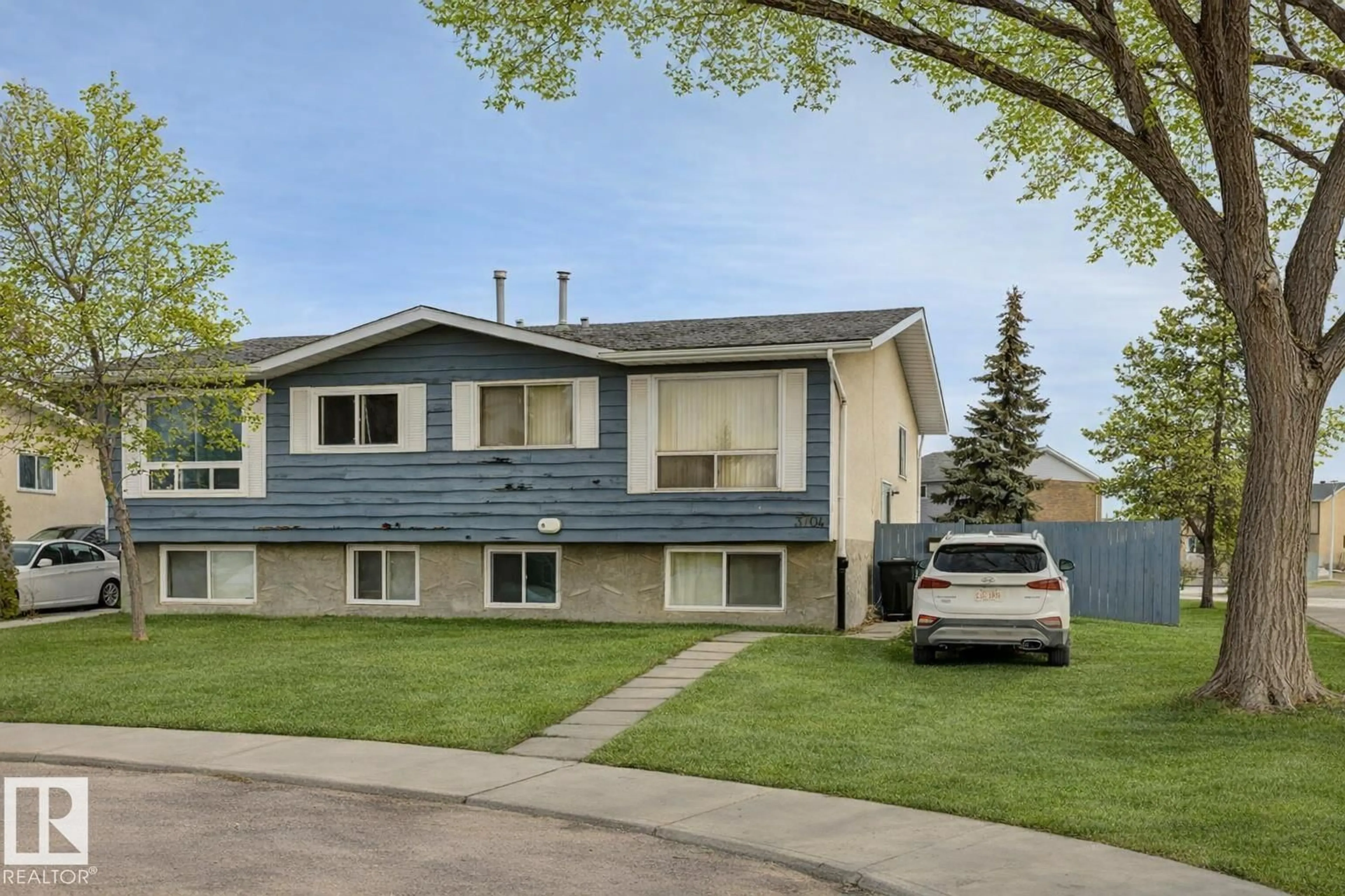 Home with vinyl exterior material, street for 3704 134 AV, Edmonton Alberta T5A3J8