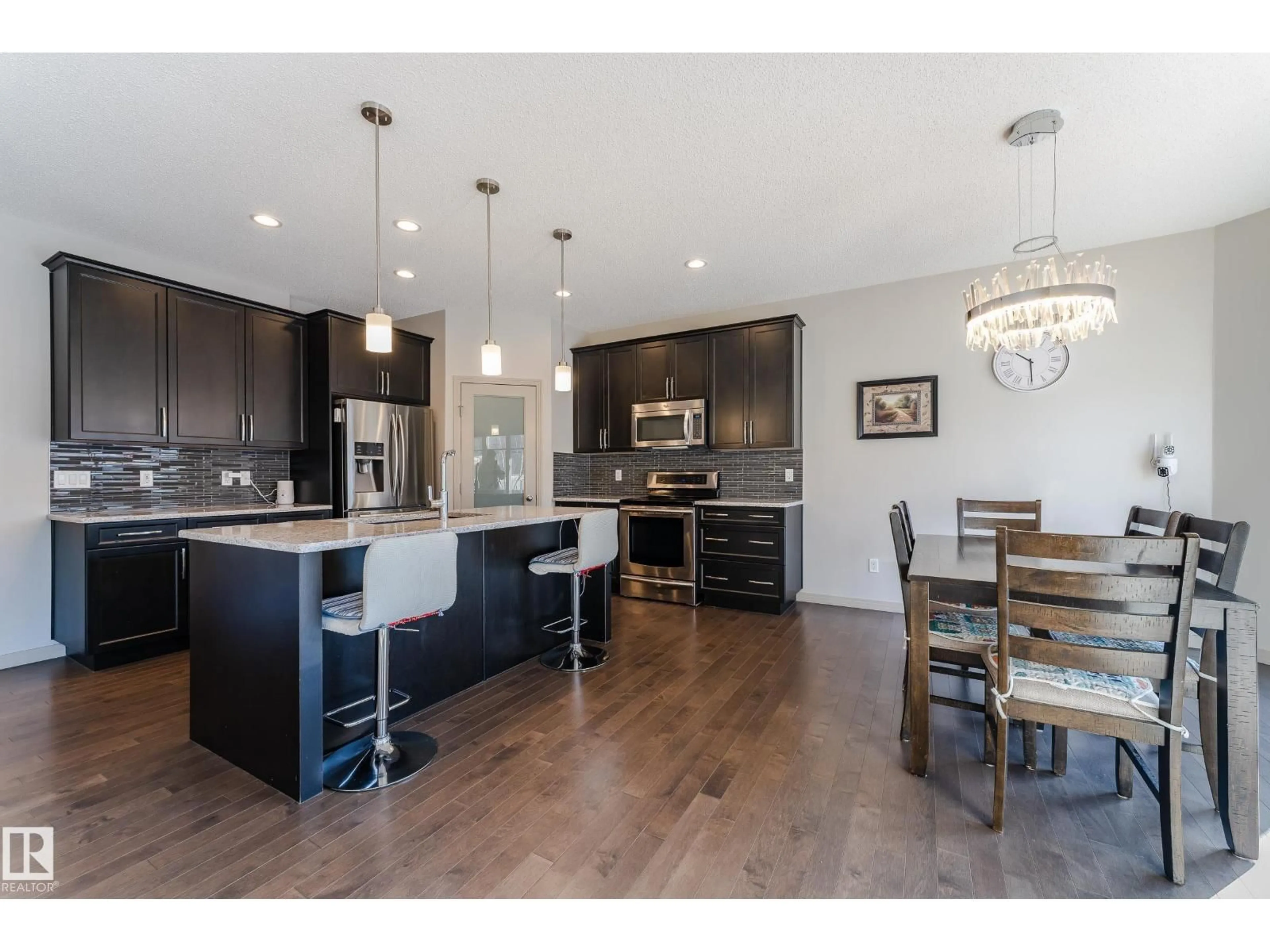 Open concept kitchen, wood/laminate floor for 1945 AINSLIE LINK, Edmonton Alberta T6W2L9