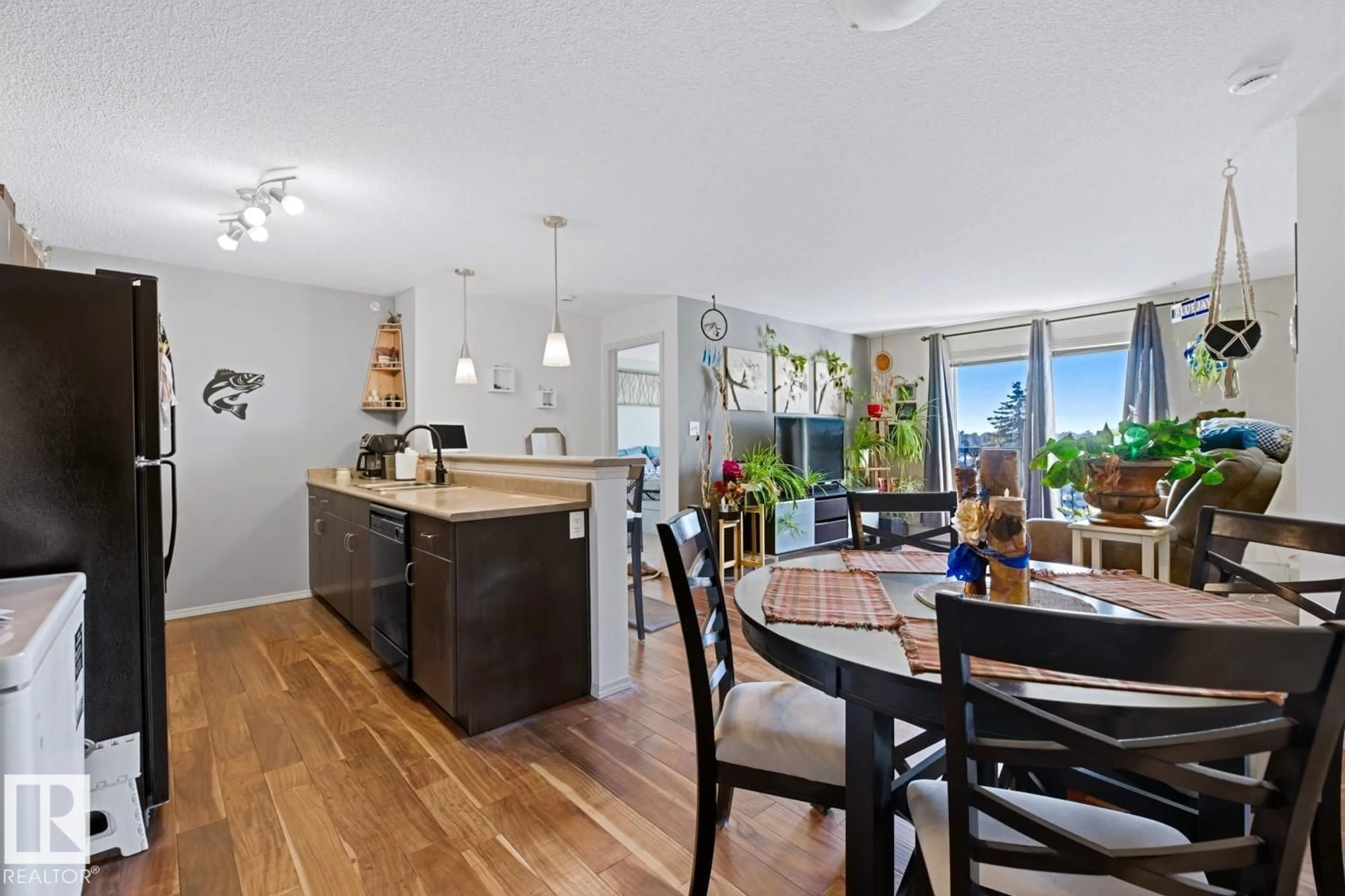 Open concept kitchen, wood/laminate floor for 1180 - 420 HYNDMAN RD, Edmonton Alberta T5A0P8