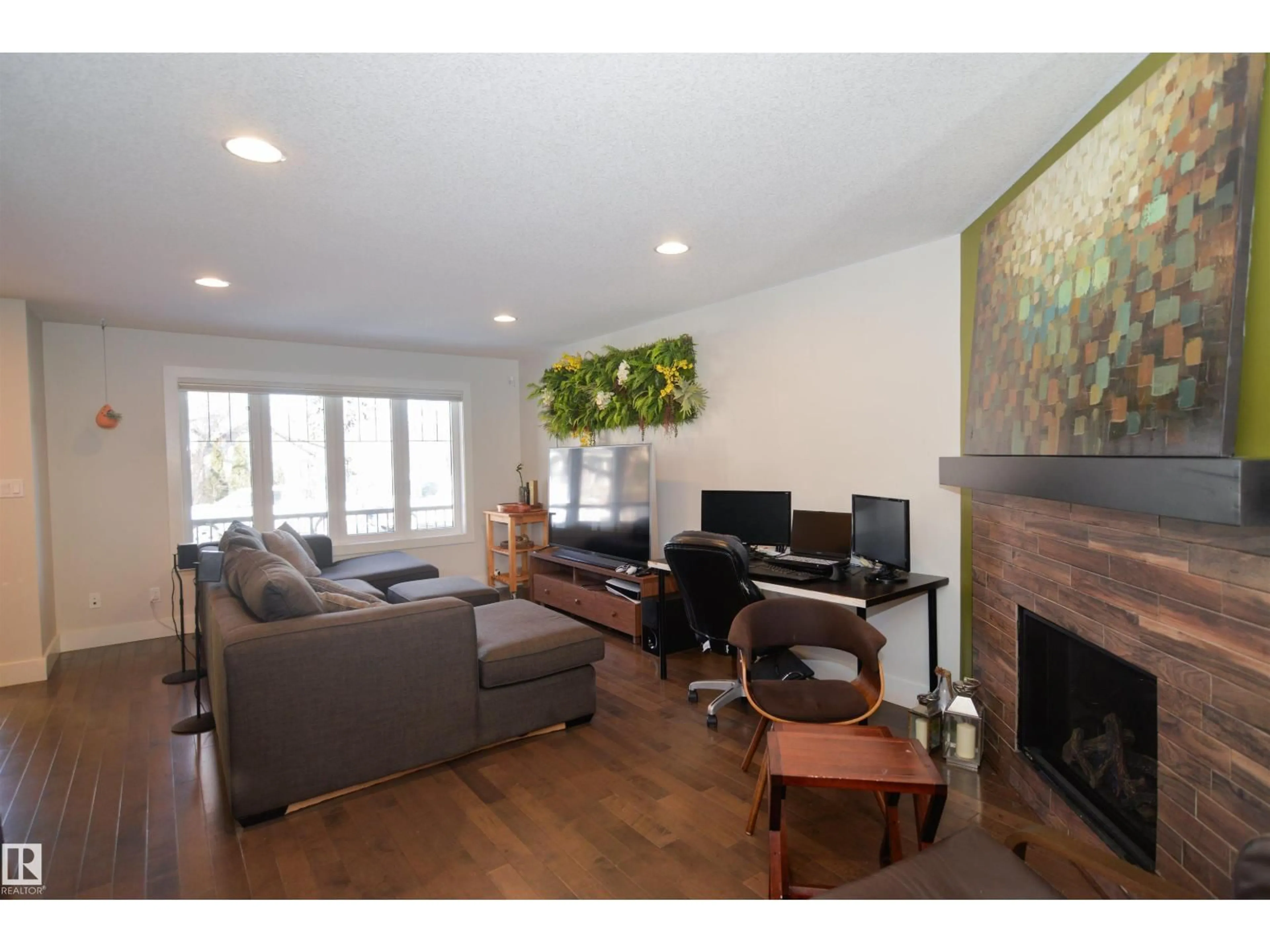 Living room with furniture, wood/laminate floor for 10433 70 AV, Edmonton Alberta T6H2E7