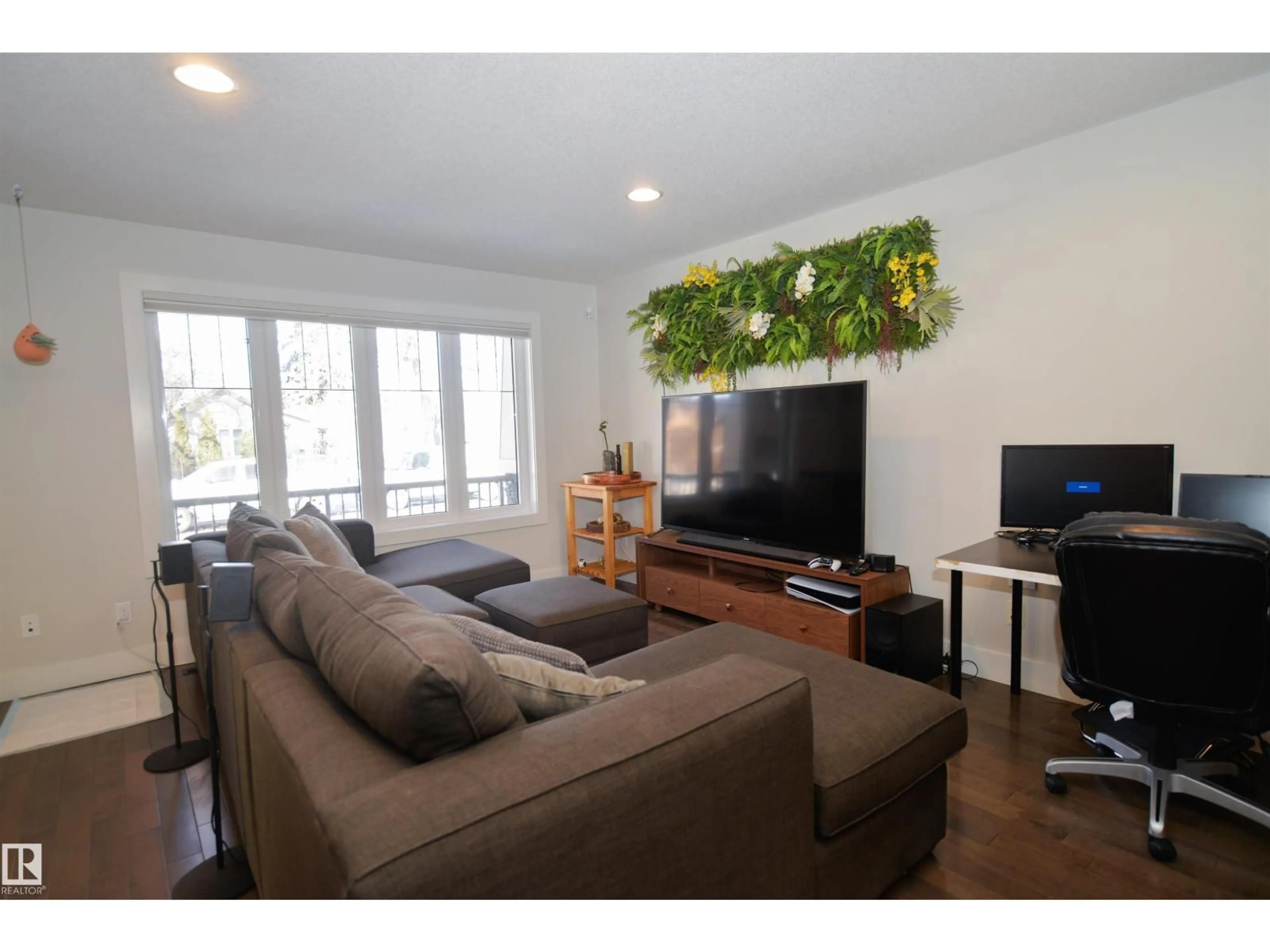 Living room with furniture, wood/laminate floor for 10433 70 AV, Edmonton Alberta T6H2E7