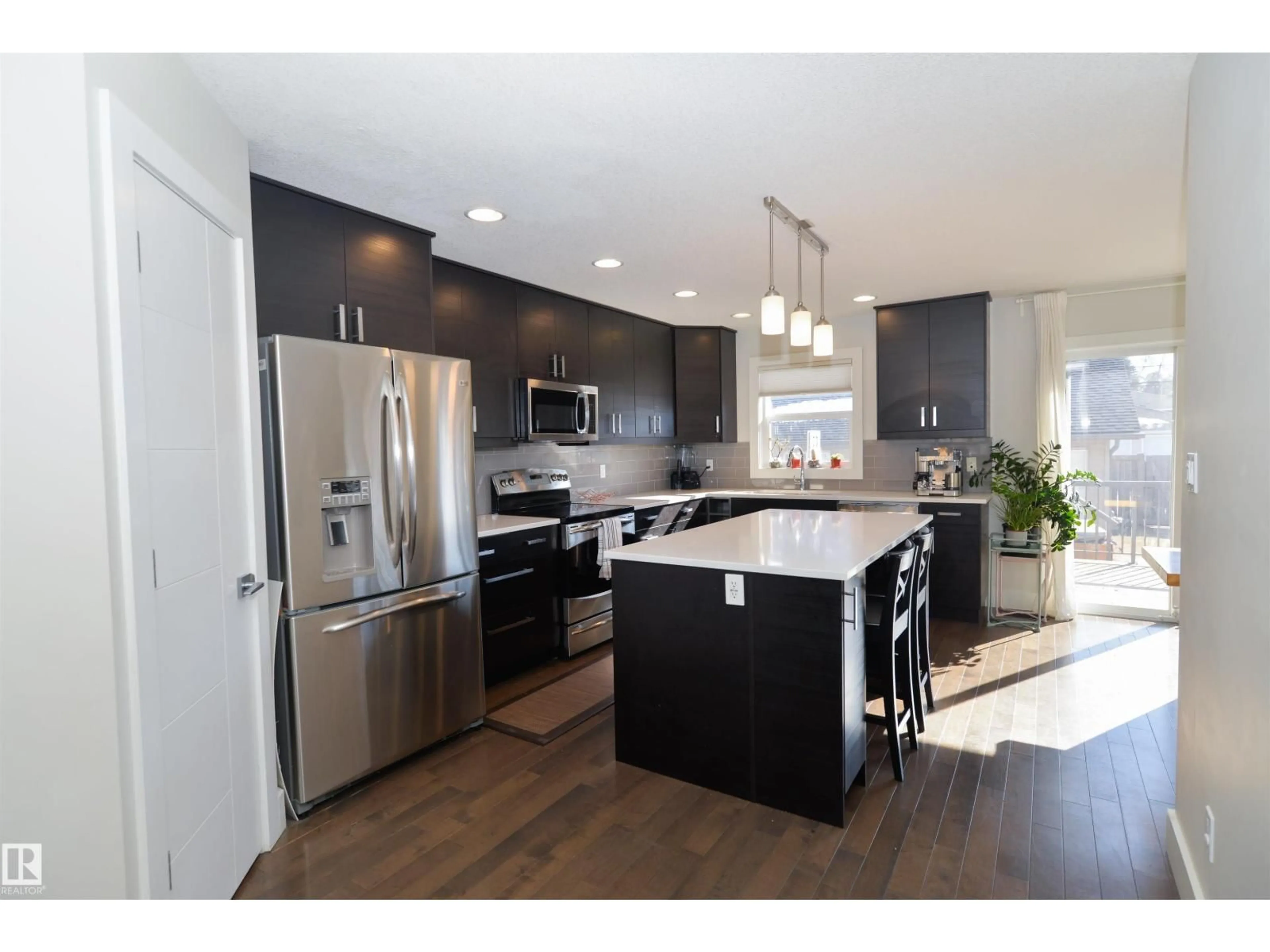 Open concept kitchen, wood/laminate floor for 10433 70 AV, Edmonton Alberta T6H2E7
