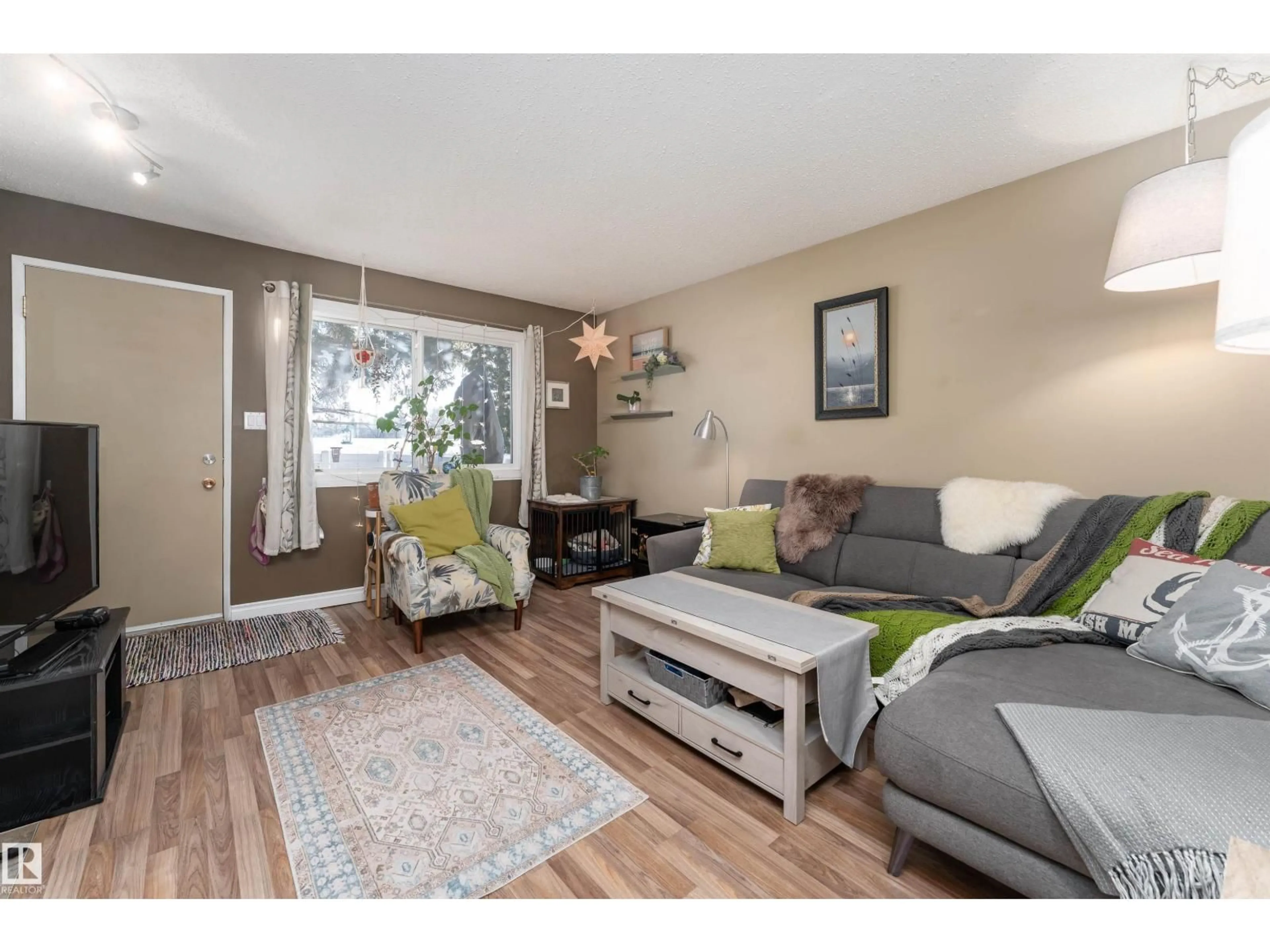 Living room with furniture, wood/laminate floor for 1229 62 ST, Edmonton Alberta T6L2H6