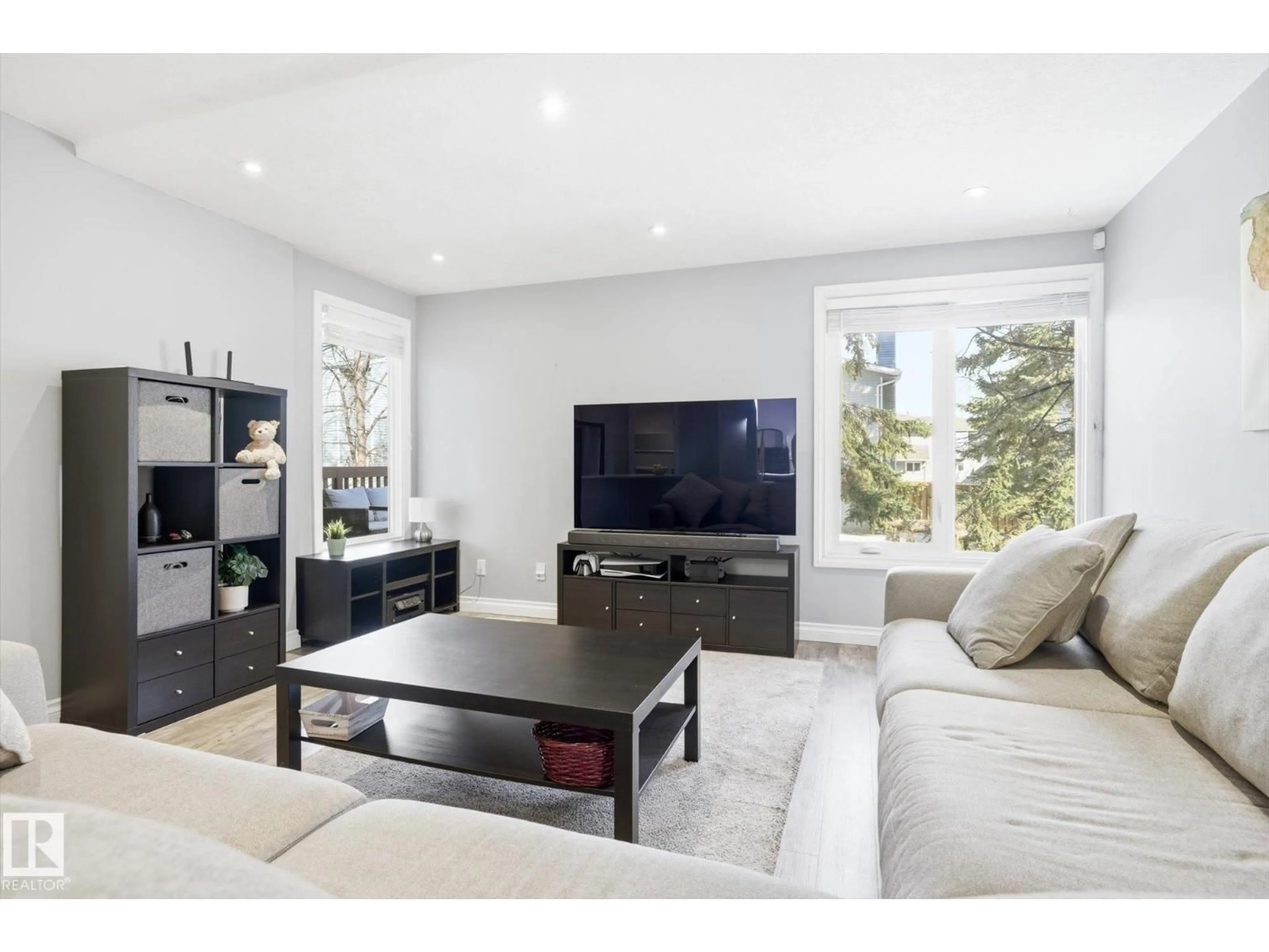 Living room with furniture, wood/laminate floor for 4333 RIVERBEND RD, Edmonton Alberta T6H5R9