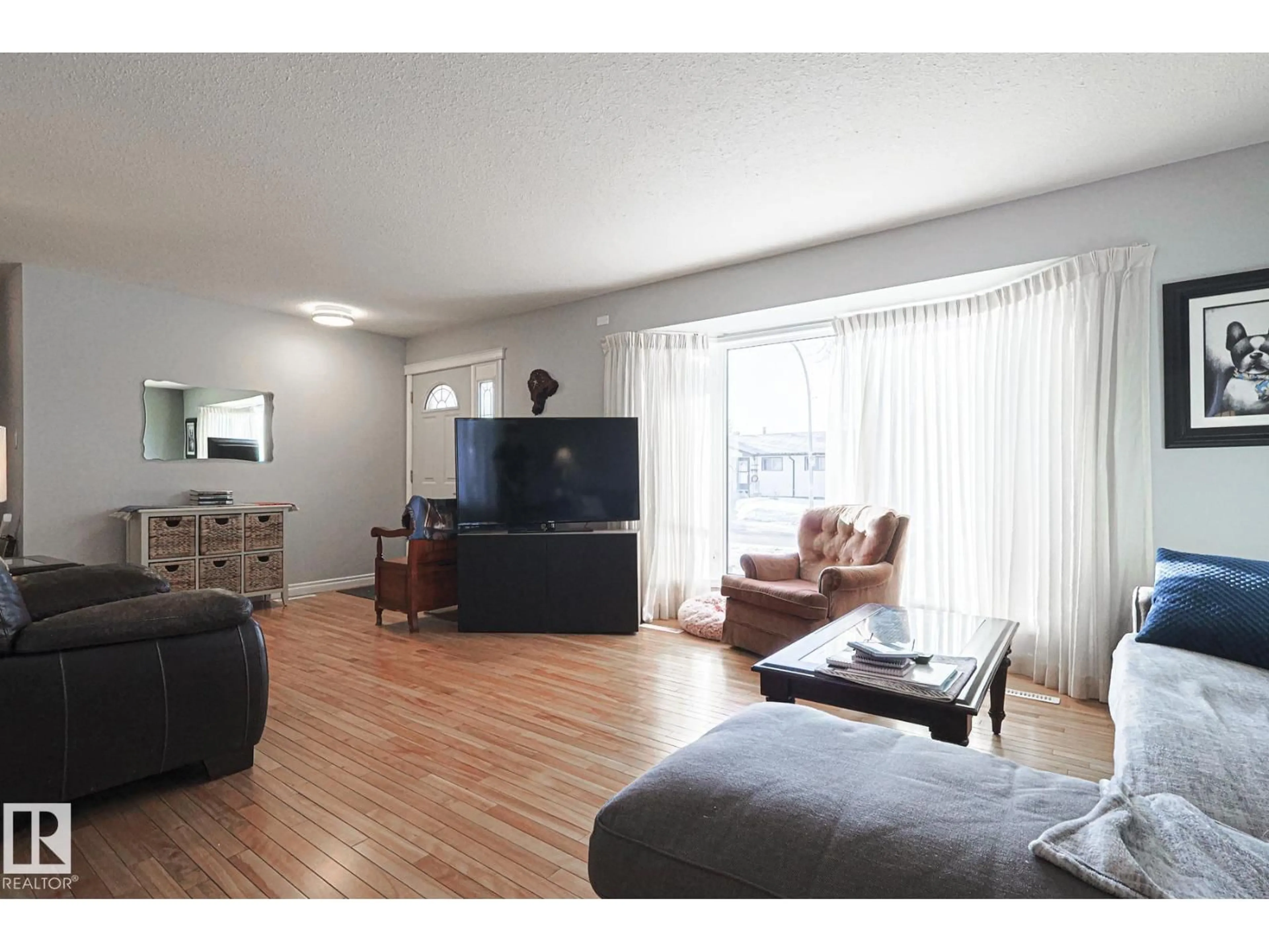 Living room with furniture, wood/laminate floor for 11148 41 AV, Edmonton Alberta T6J0T4