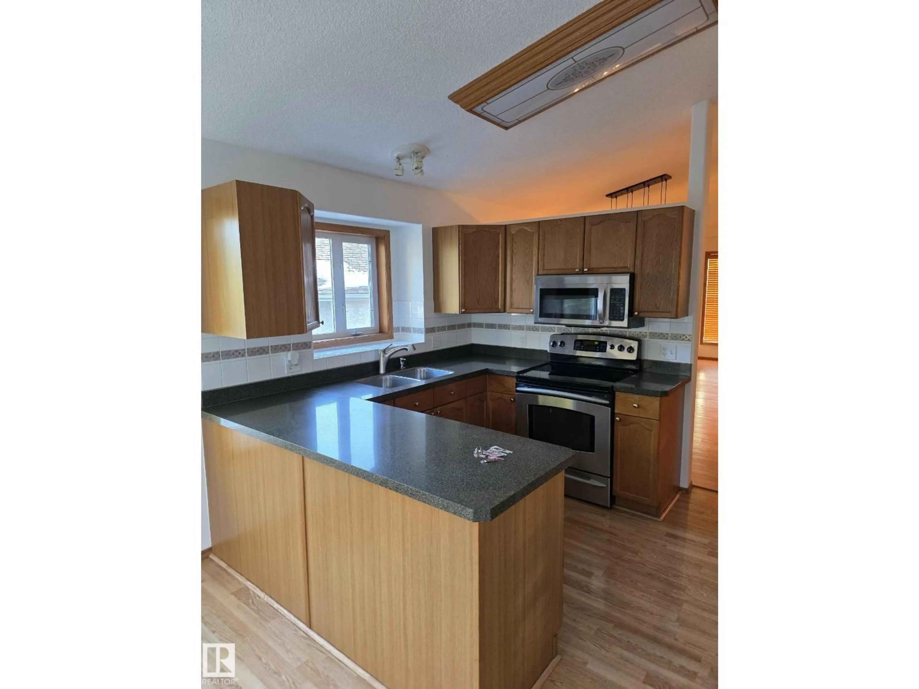 Open concept kitchen, wood/laminate floor for 15 OLMSTEAD CT, St. Albert Alberta T8N6R5