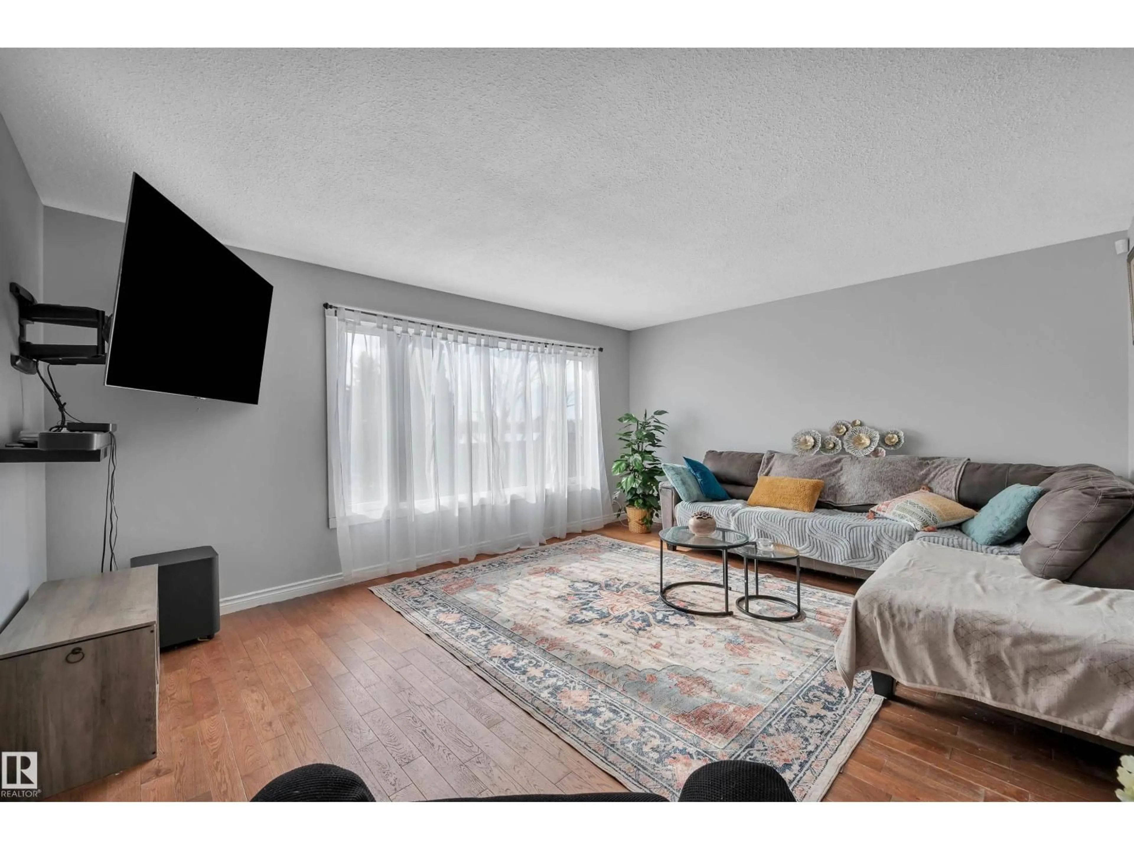 Living room with furniture, wood/laminate floor for NW - 8408 133 A AV, Edmonton Alberta T5E1E9