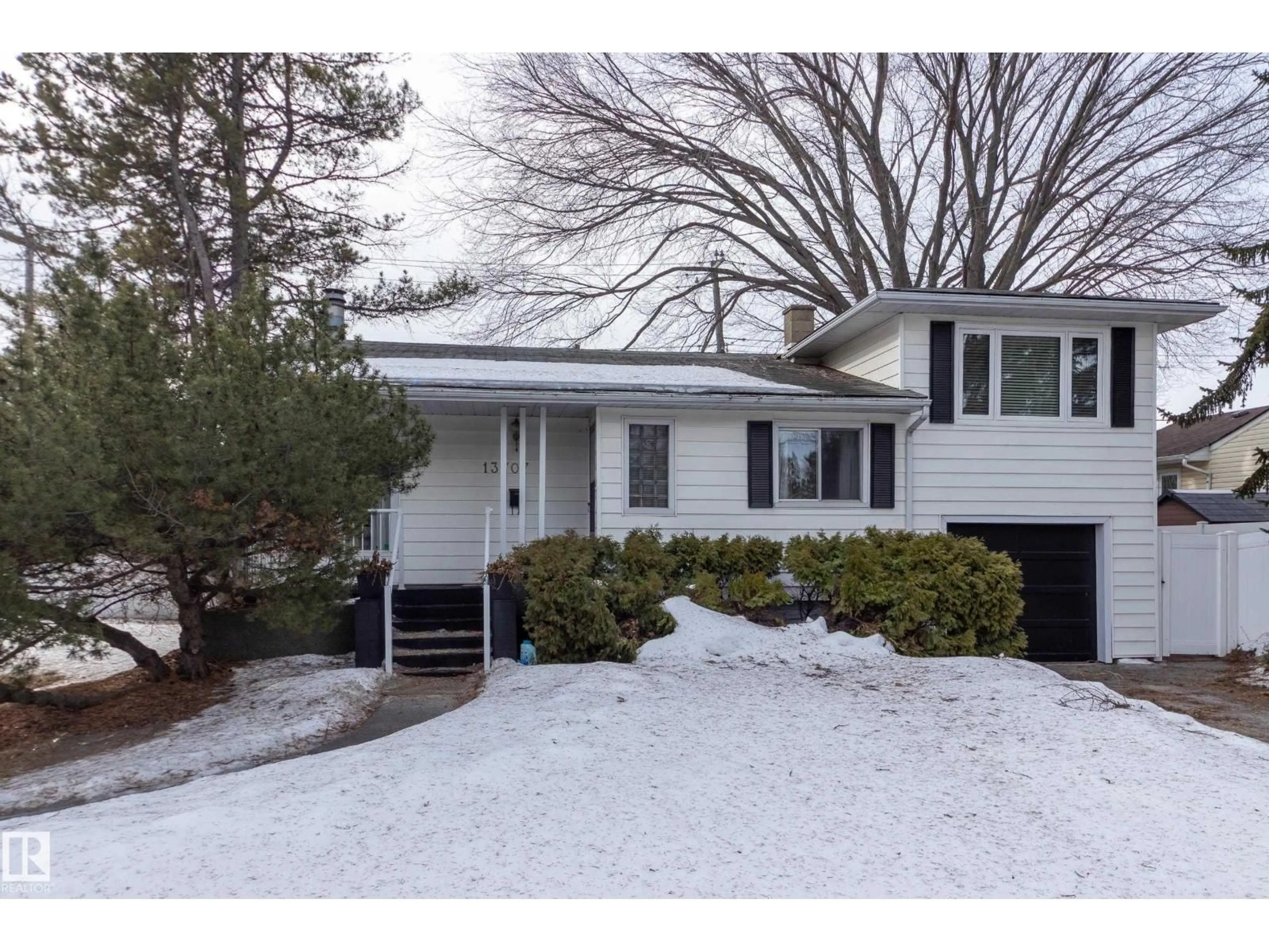 Home with vinyl exterior material, street for 13707 102 AV, Edmonton Alberta T5N0P2