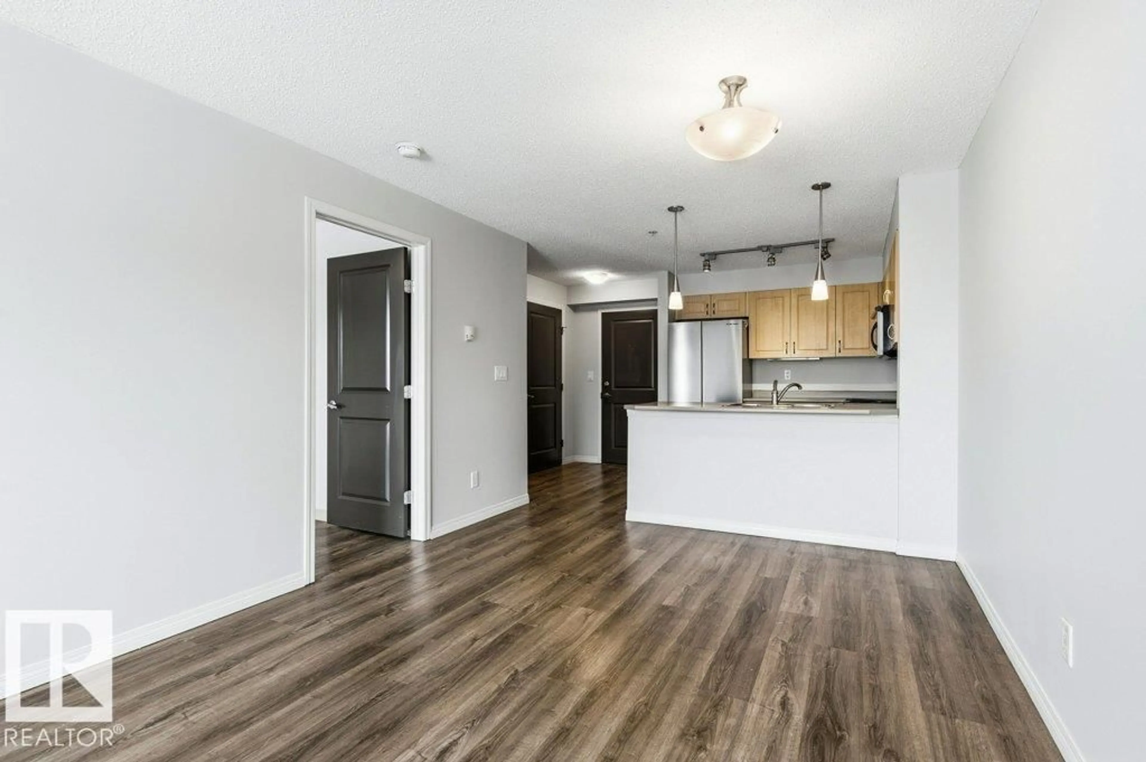 Open concept kitchen, wood/laminate floor for #304 - 11453 ELLERSLIE RD, Edmonton Alberta T6W1T3