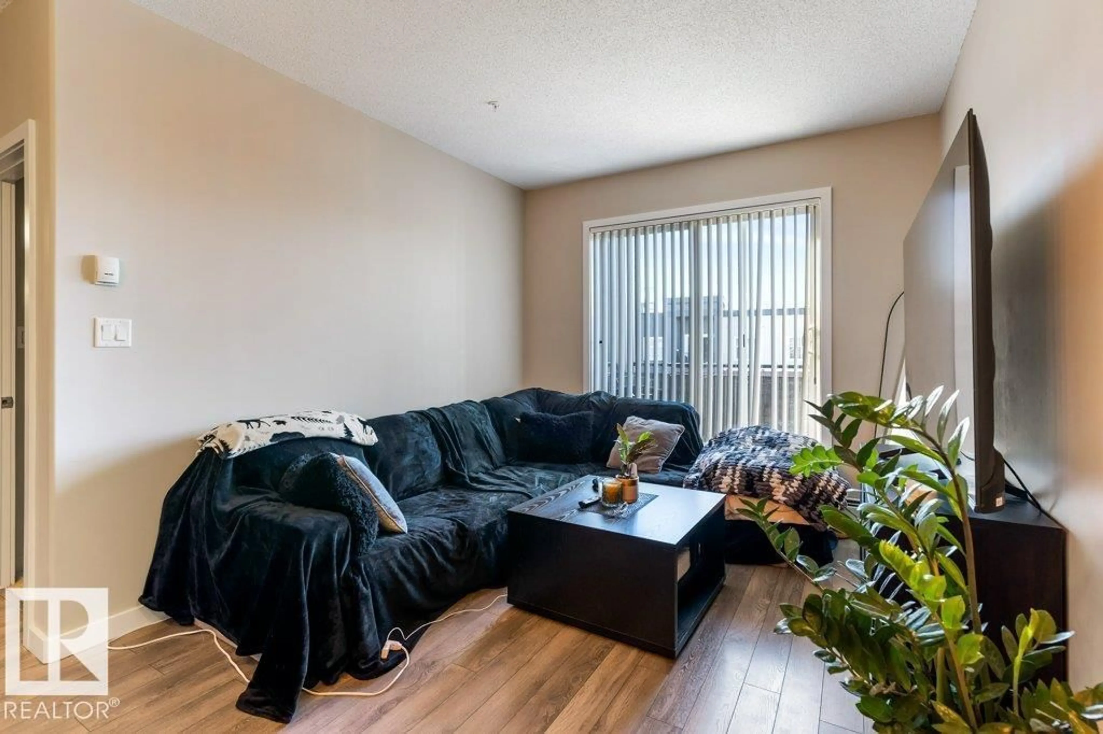 Living room with furniture, wood/laminate floor for #404 - 504 GRIESBACH PARADE, Edmonton Alberta T5E6V9