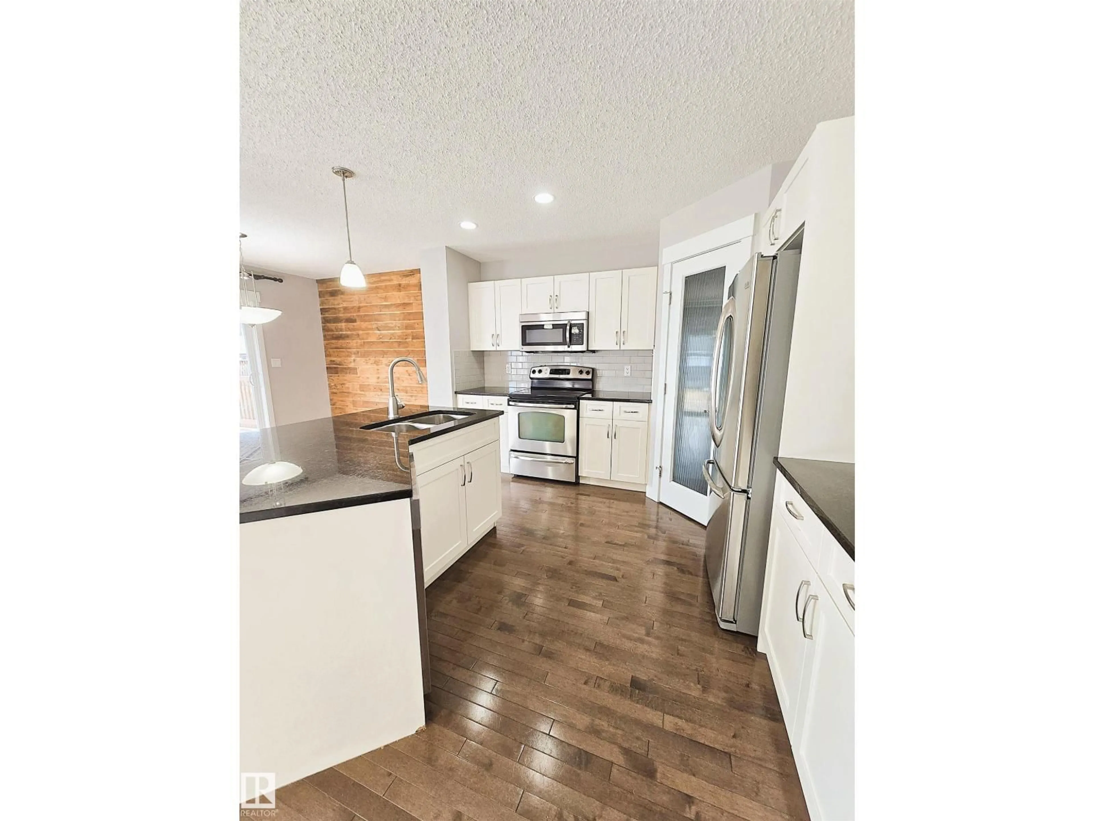 Open concept kitchen, wood/laminate floor for 475 REED CR, Leduc Alberta T9E0R5