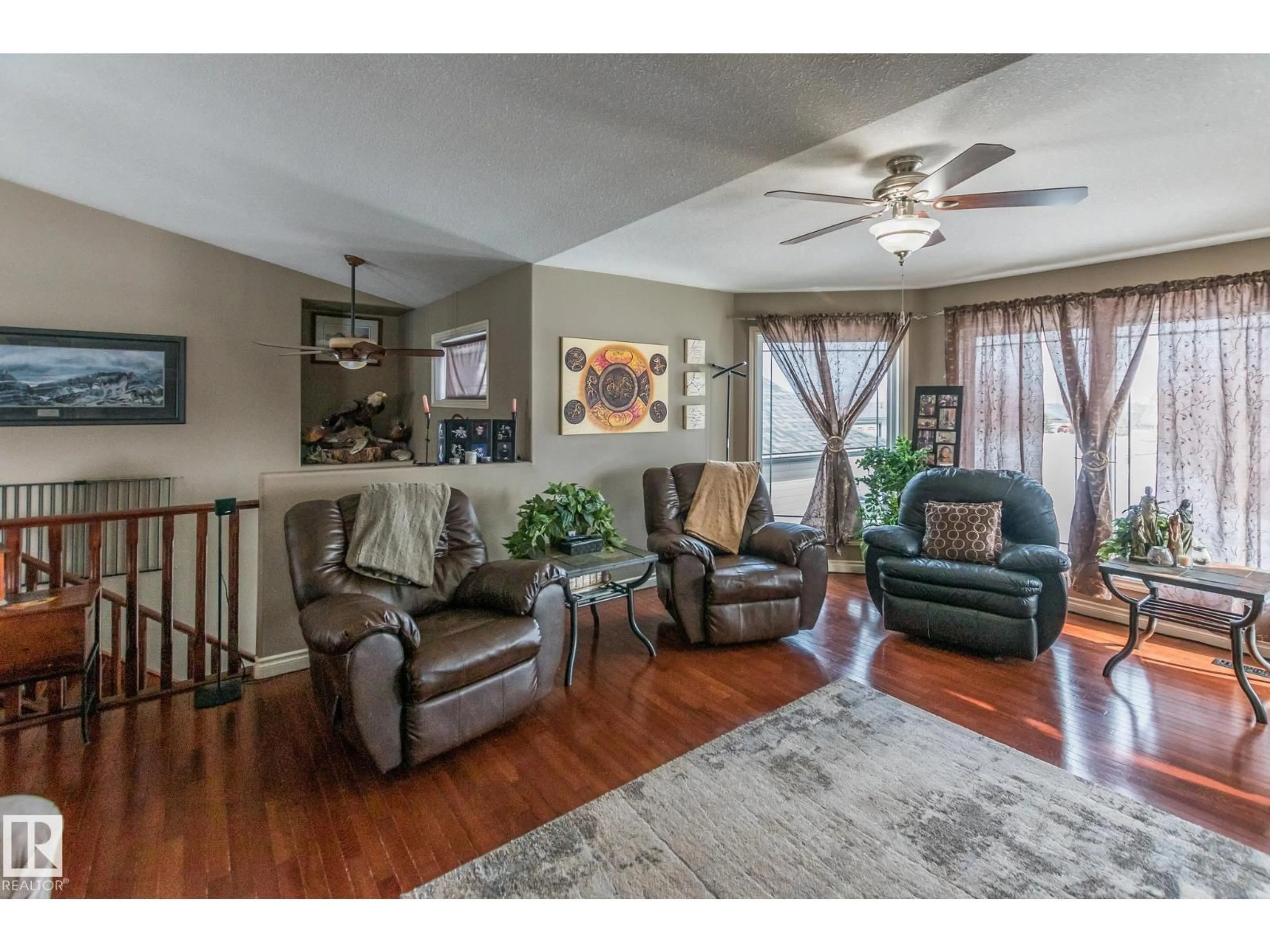 Living room with furniture, wood/laminate floor for 46324 - 40 TWP RD 611, Rural Bonnyville M.D. Alberta T9N2G6