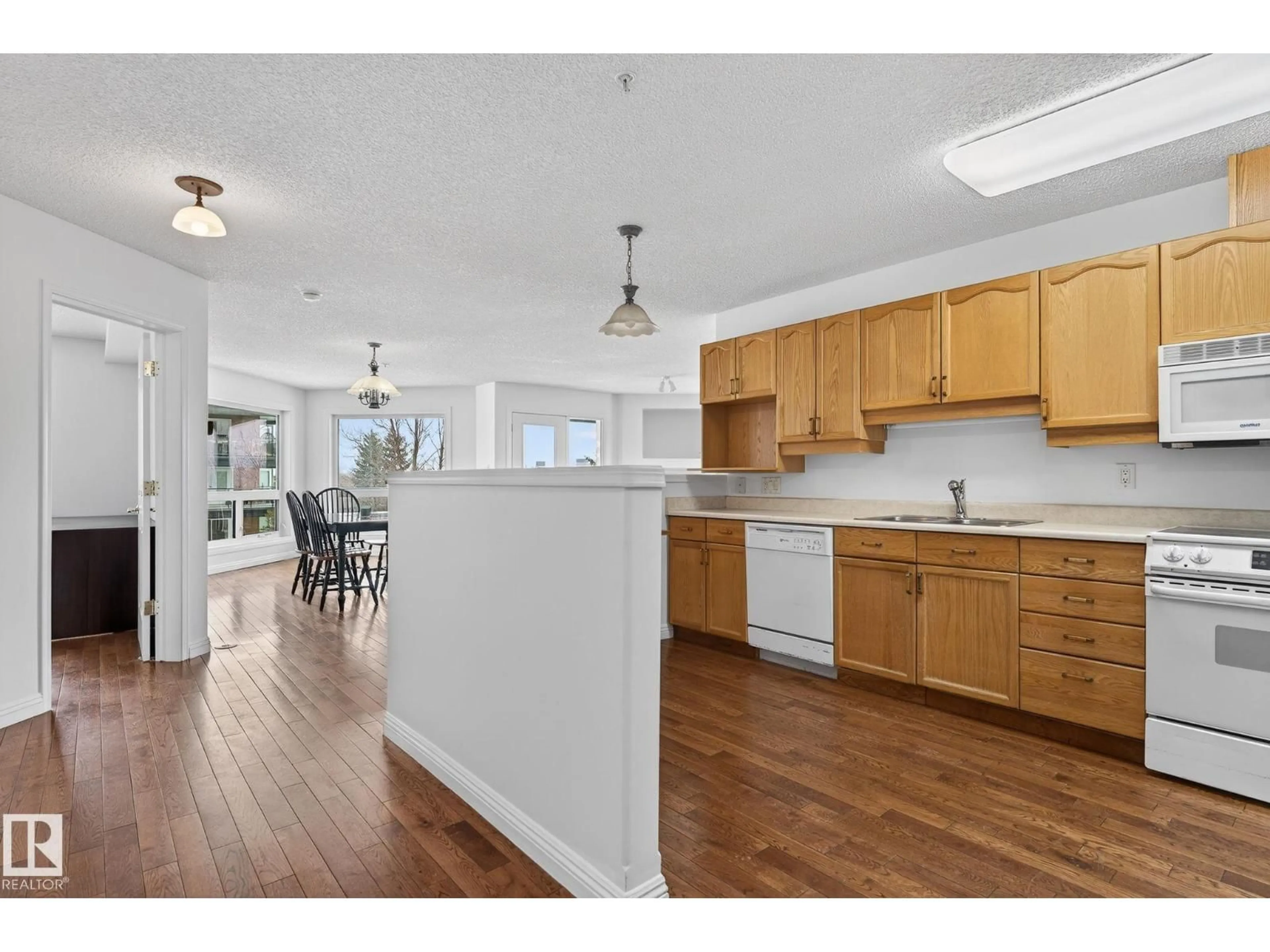 Open concept kitchen, wood/laminate floor for #303 - 7839 96 ST, Edmonton Alberta T6C4R4