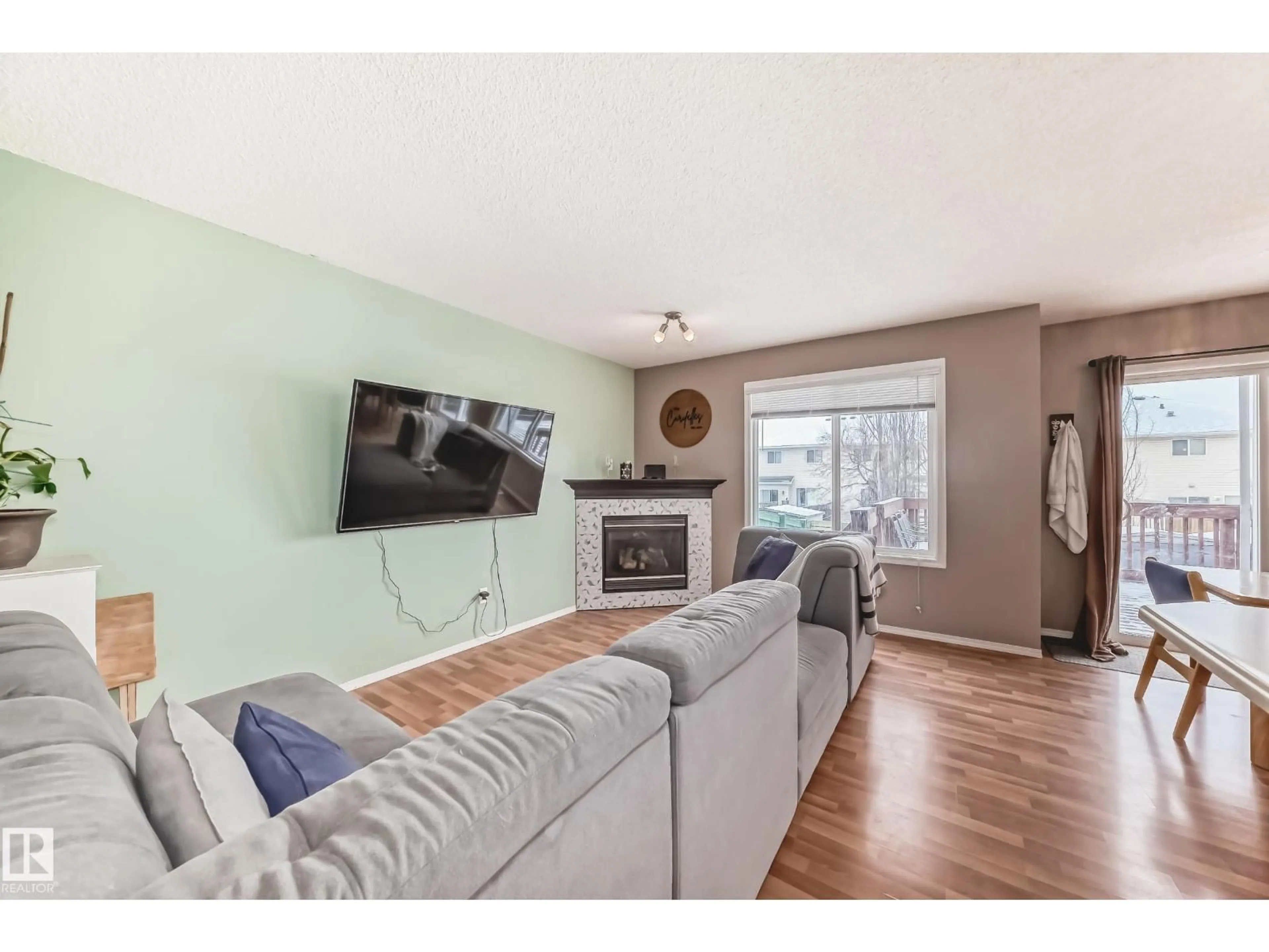 Living room with furniture, wood/laminate floor for 42 - 115 CHESTERMERE DR, Sherwood Park Alberta T8H2W4