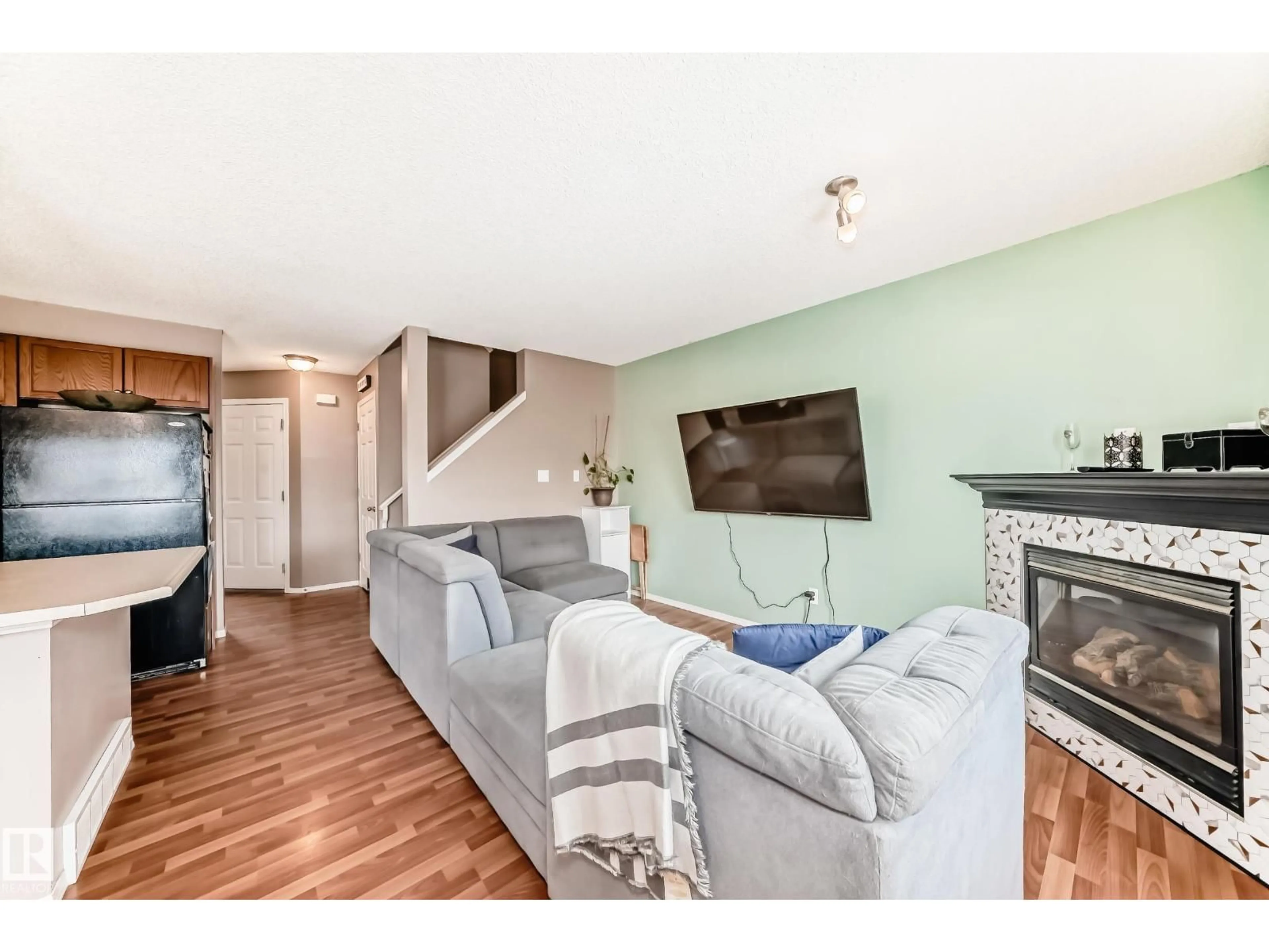 Living room with furniture, wood/laminate floor for 42 - 115 CHESTERMERE DR, Sherwood Park Alberta T8H2W4