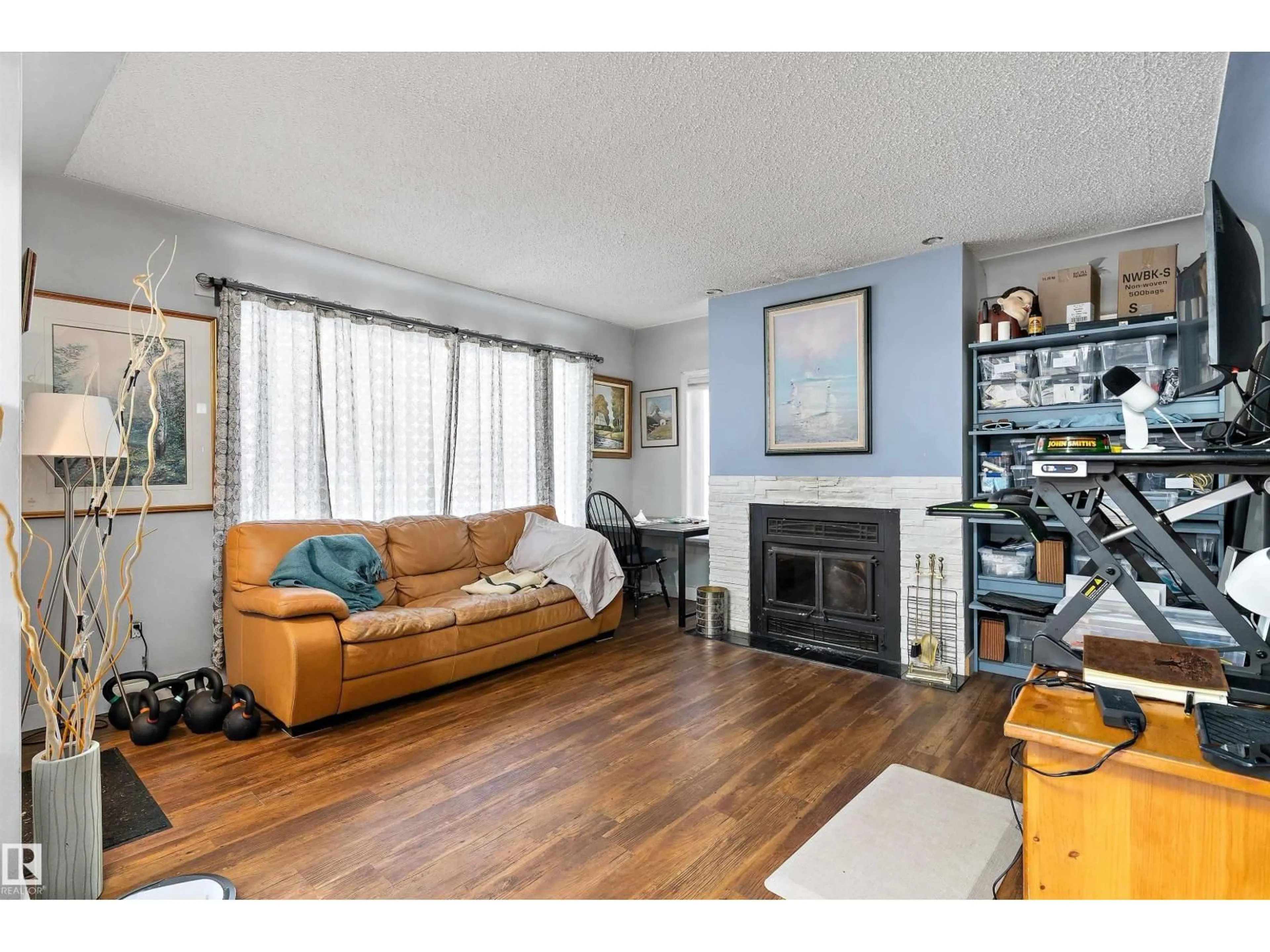 Living room with furniture, wood/laminate floor for 10919 116 ST, Edmonton Alberta T5H3M7