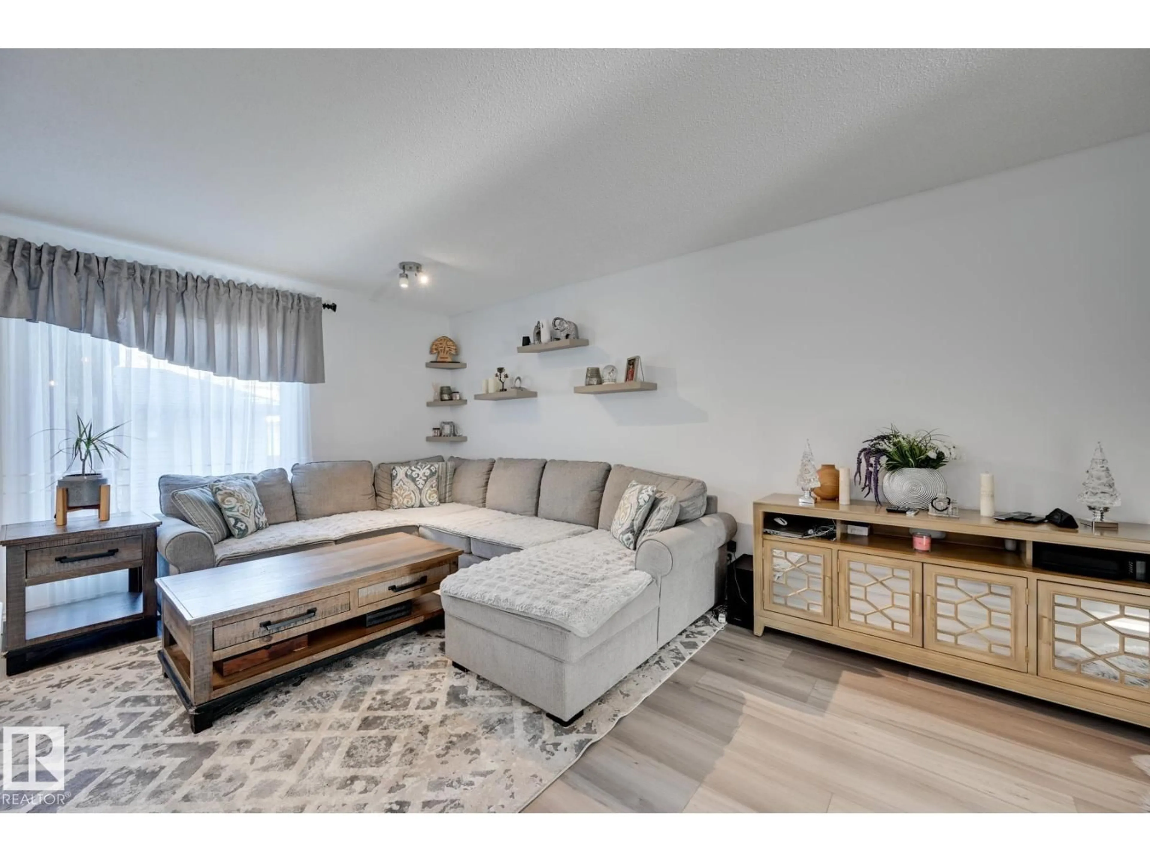 Living room with furniture, wood/laminate floor for 14803 - 59 MILLER BV, Edmonton Alberta T5Y3A4