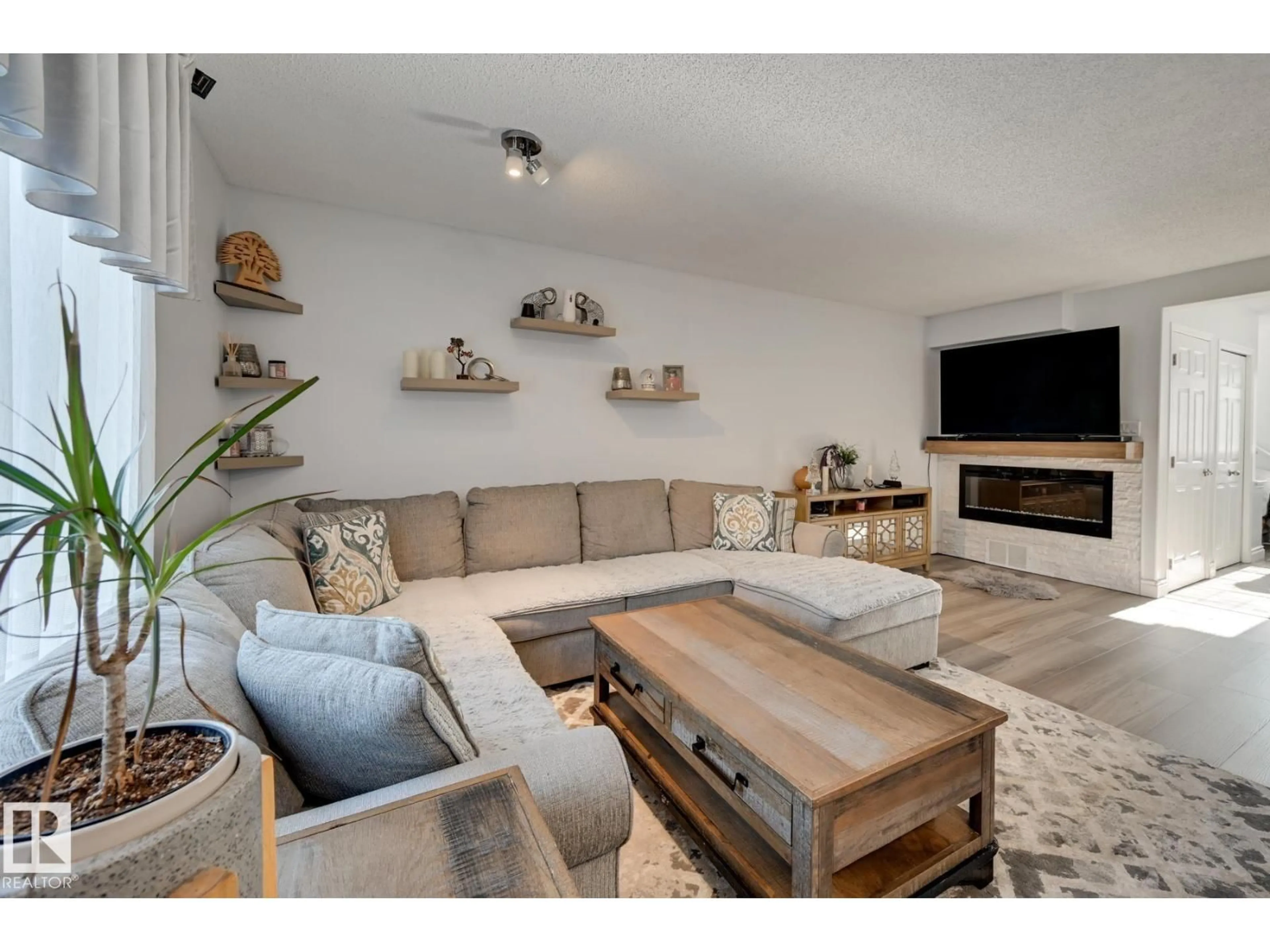 Living room with furniture, wood/laminate floor for 14803 - 59 MILLER BV, Edmonton Alberta T5Y3A4