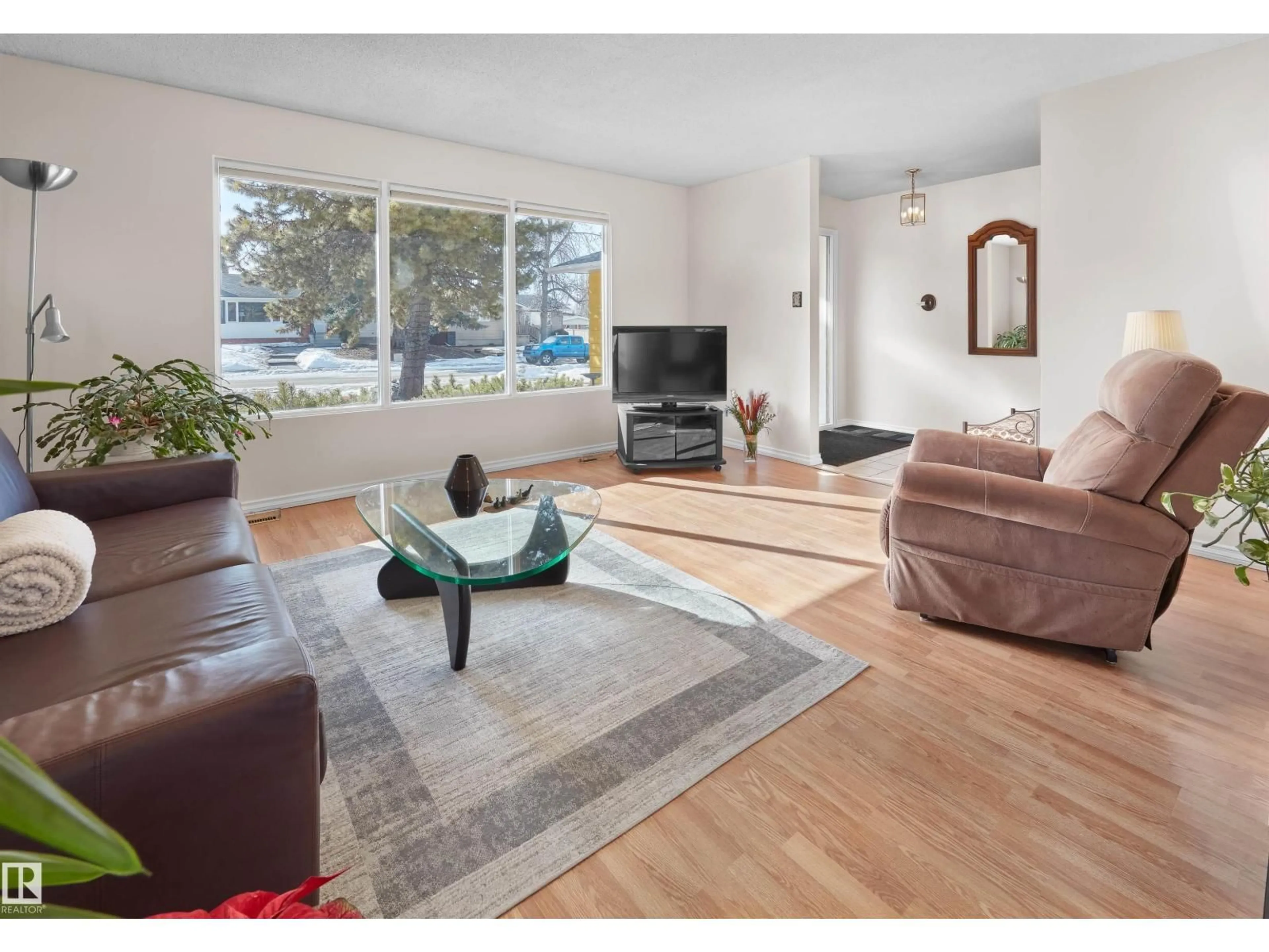 Living room with furniture, wood/laminate floor for 10928 36A AV, Edmonton Alberta T6J0E4