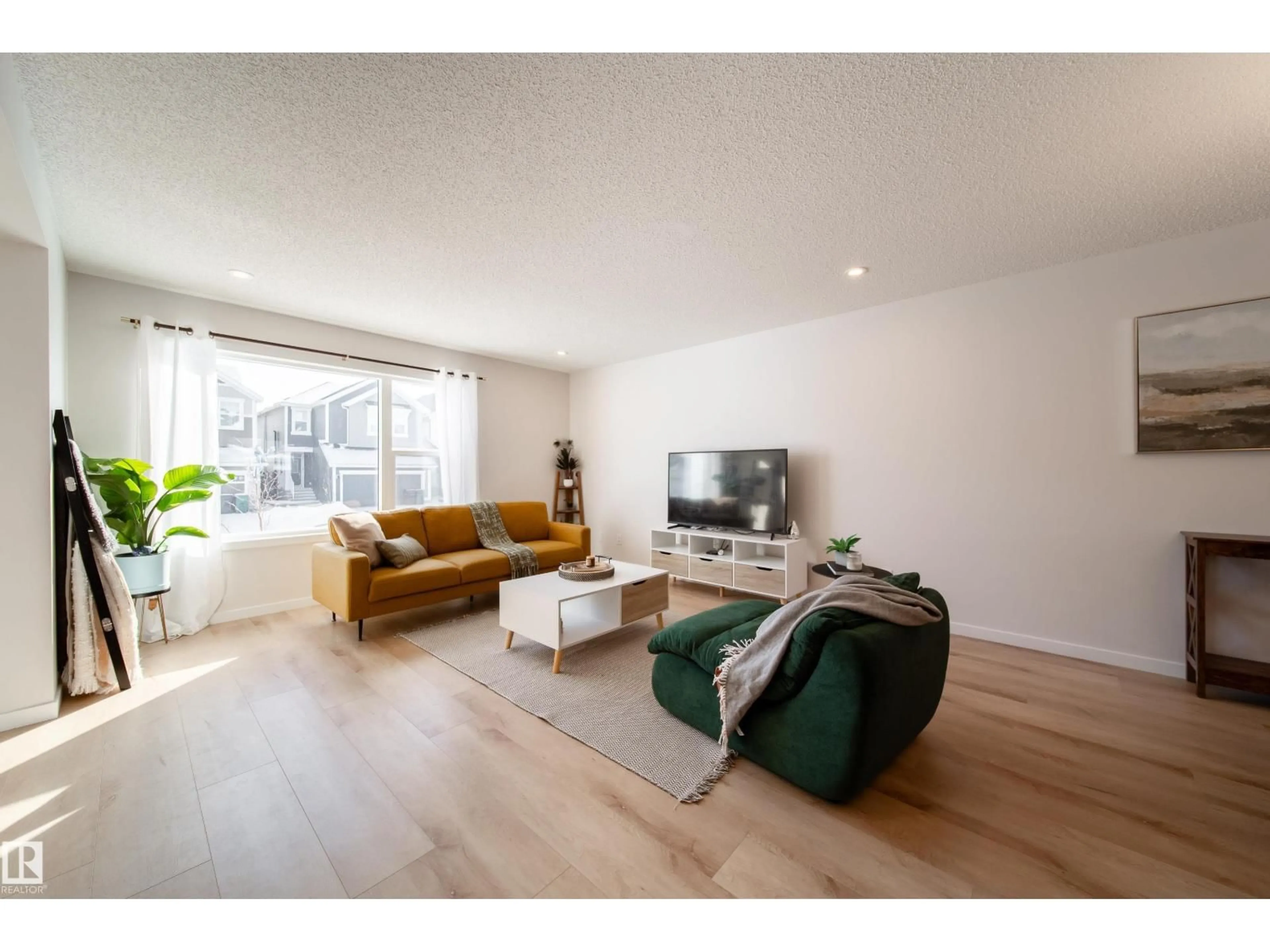 Living room with furniture, wood/laminate floor for 112 STONEHOUSE WY, Leduc Alberta T9E1R1