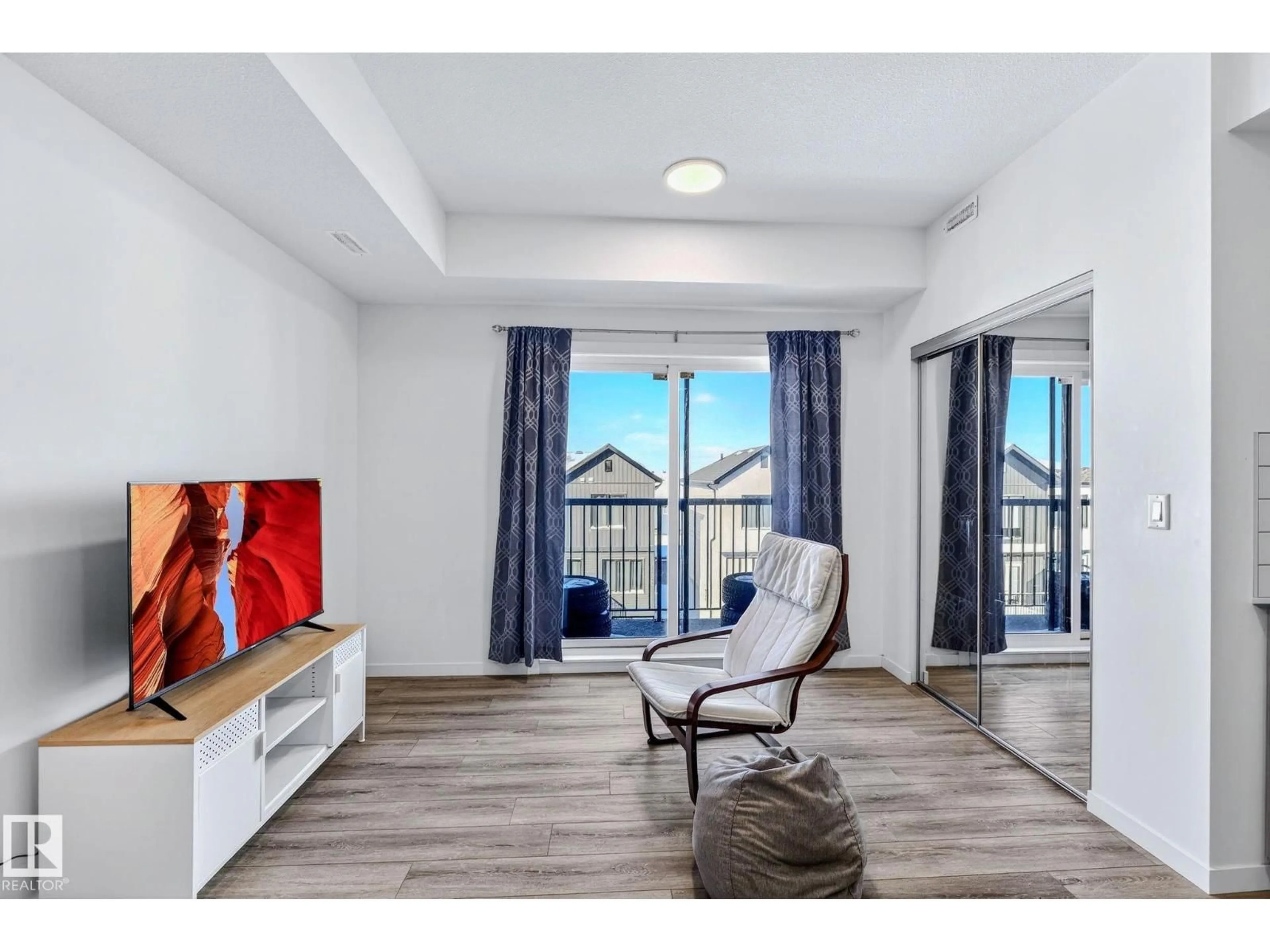 Living room with furniture, wood/laminate floor for 301 - 864 SECORD BV, Edmonton Alberta T5T7R9