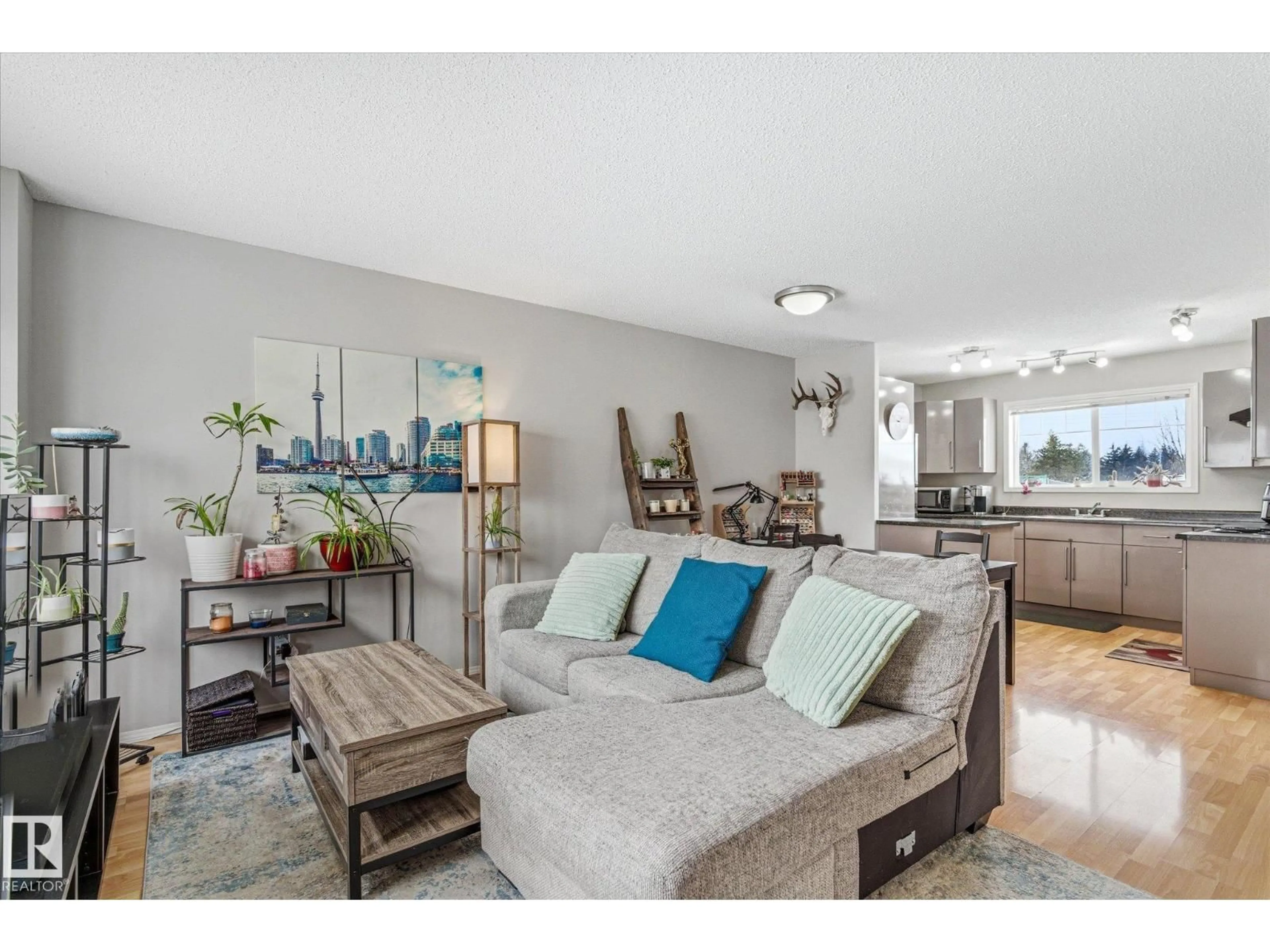 Living room with furniture, wood/laminate floor for 70 - 69 CAVAN RD, Sherwood Park Alberta T8H2K7