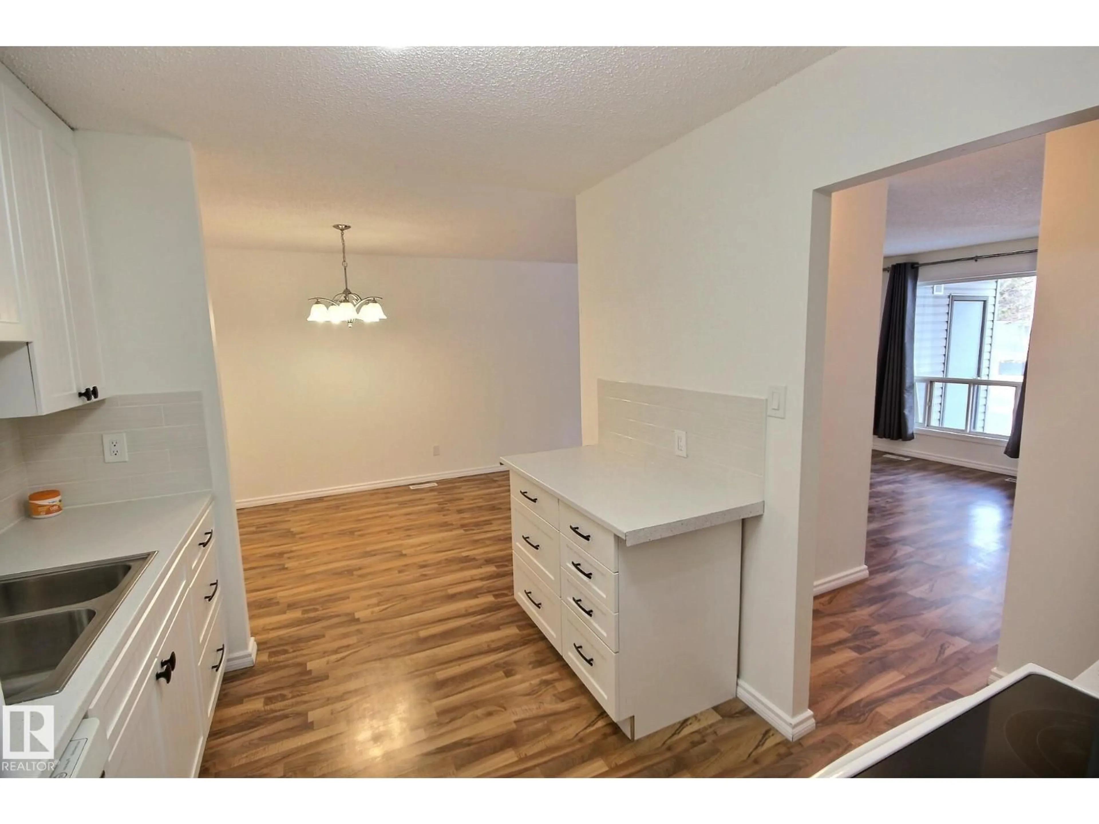 Open concept kitchen, wood/laminate floor for #11 - 1503 MILL WOODS RD E, Edmonton Alberta T6L4C2
