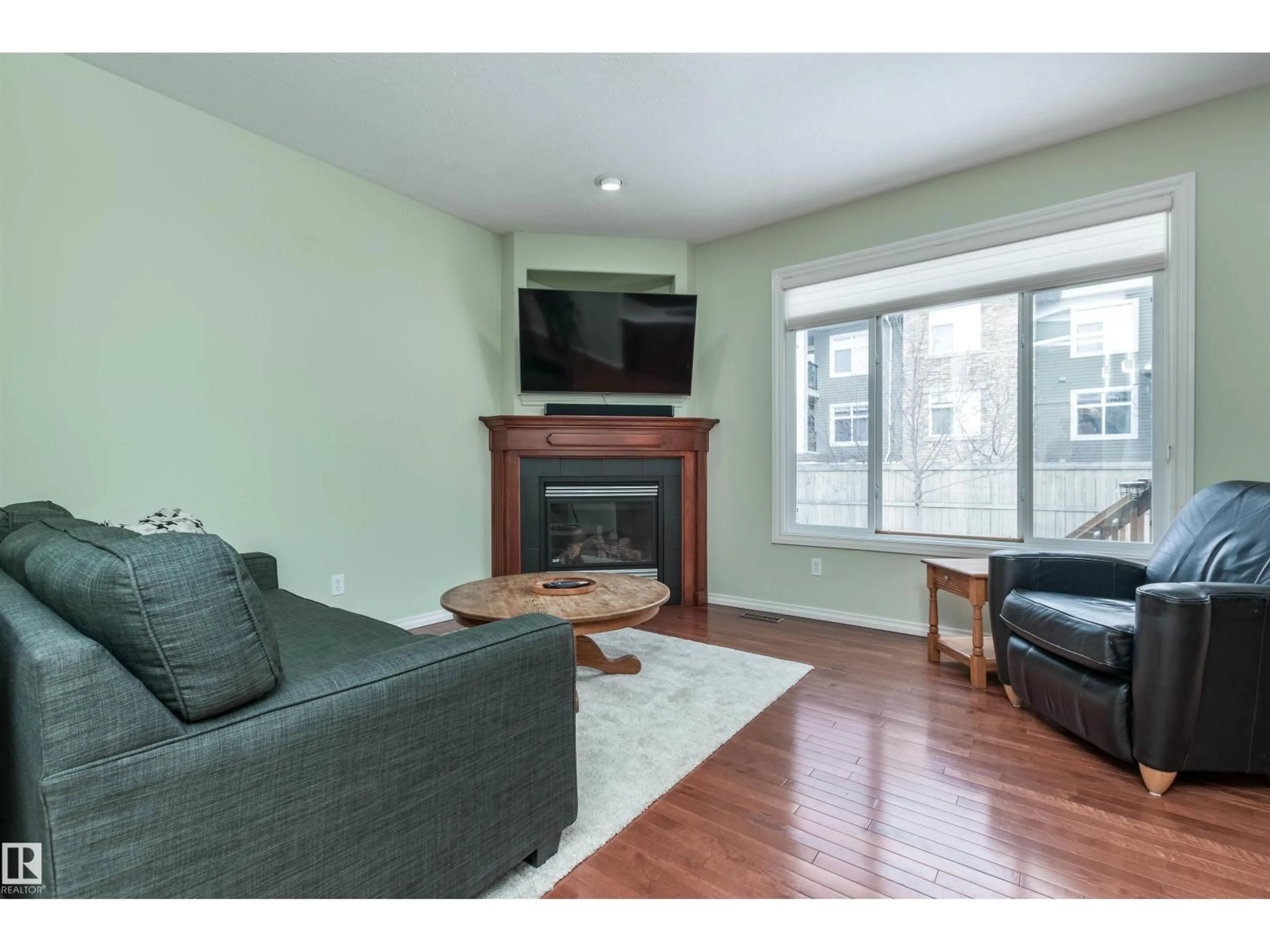 Living room with furniture, wood/laminate floor for SW - 11548 11 AV, Edmonton Alberta T6W1W8