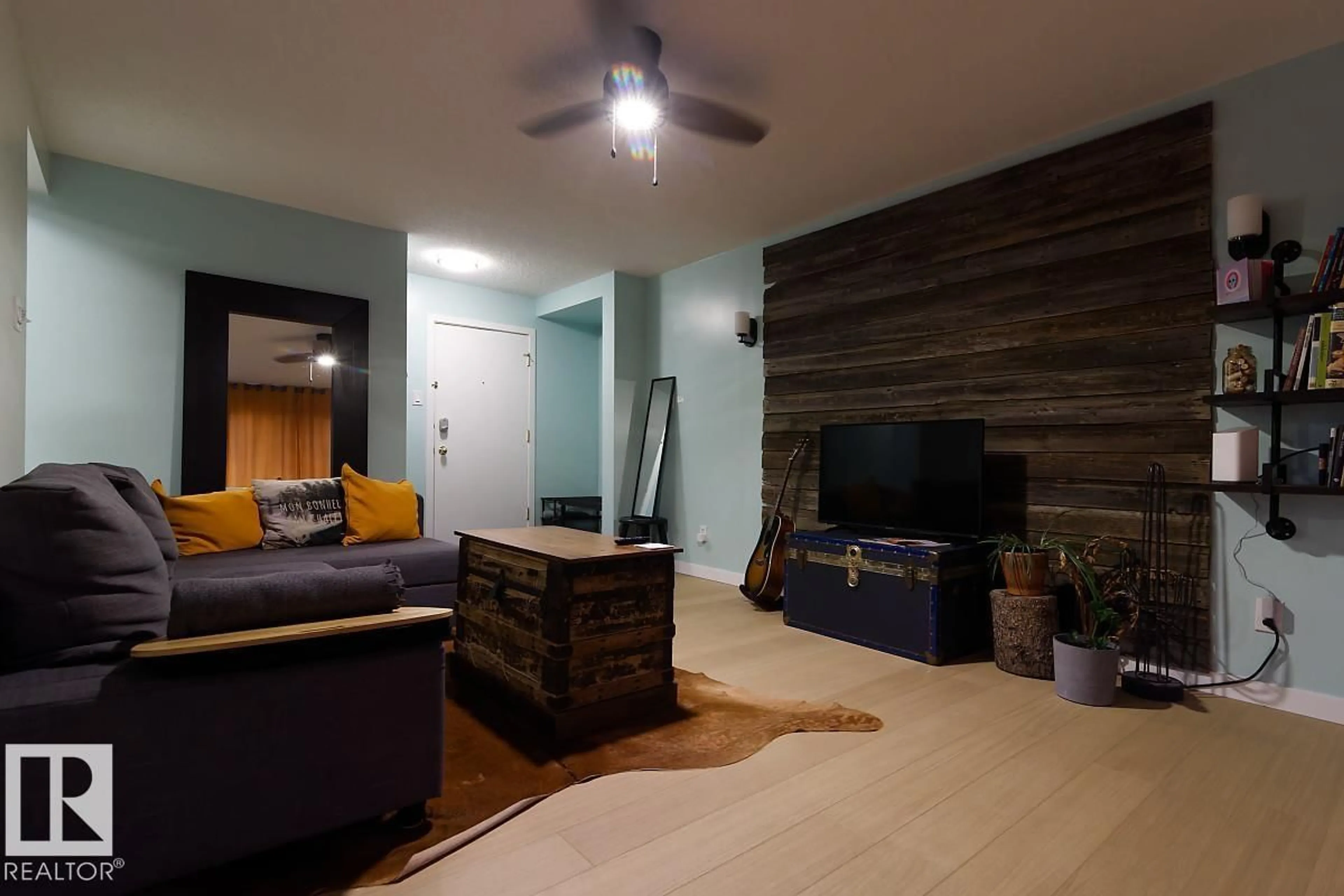 Living room with furniture, wood/laminate floor for 11217 103 AV NW, Edmonton Alberta T5K2V9