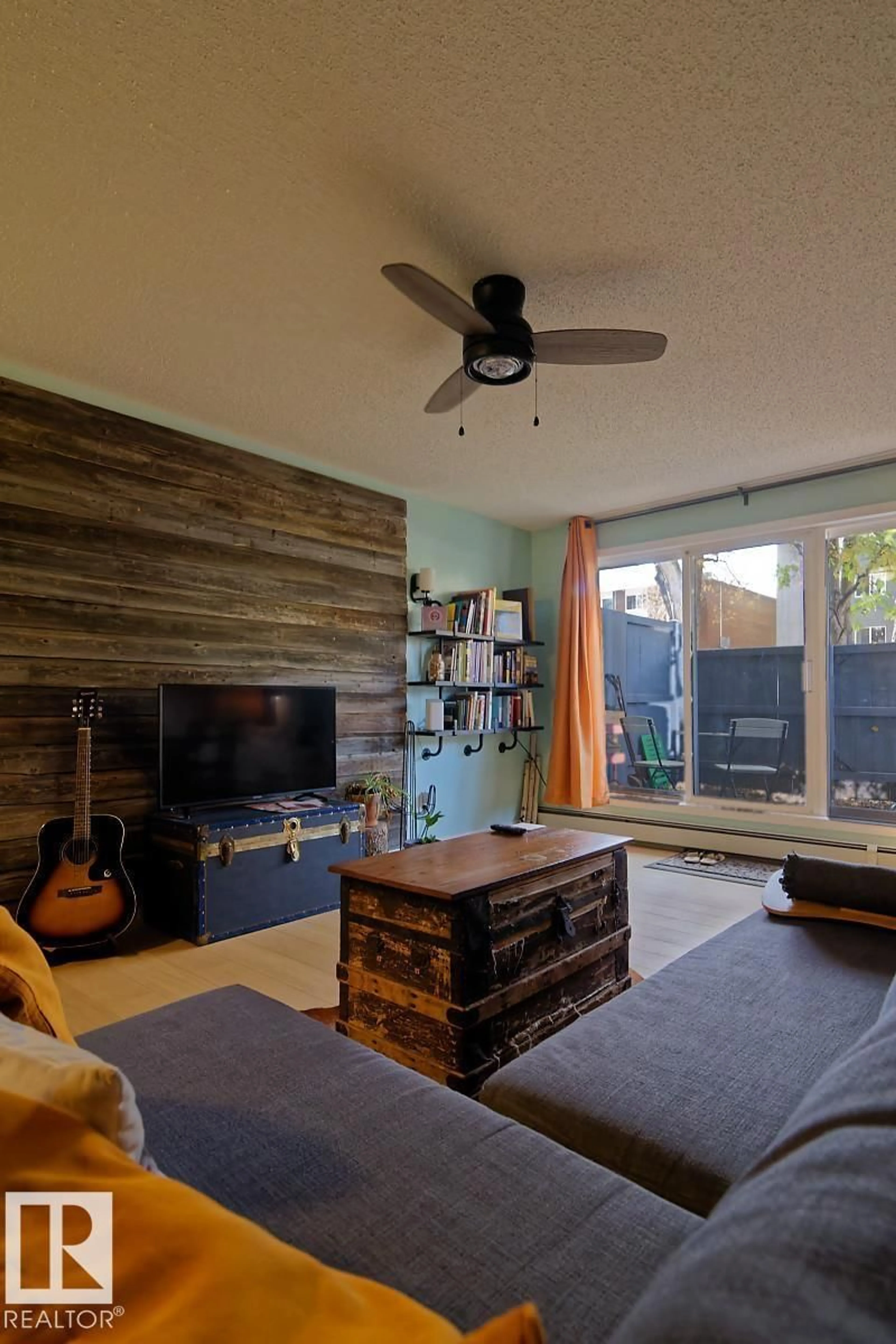 Living room with furniture, wood/laminate floor for 11217 103 AV NW, Edmonton Alberta T5K2V9