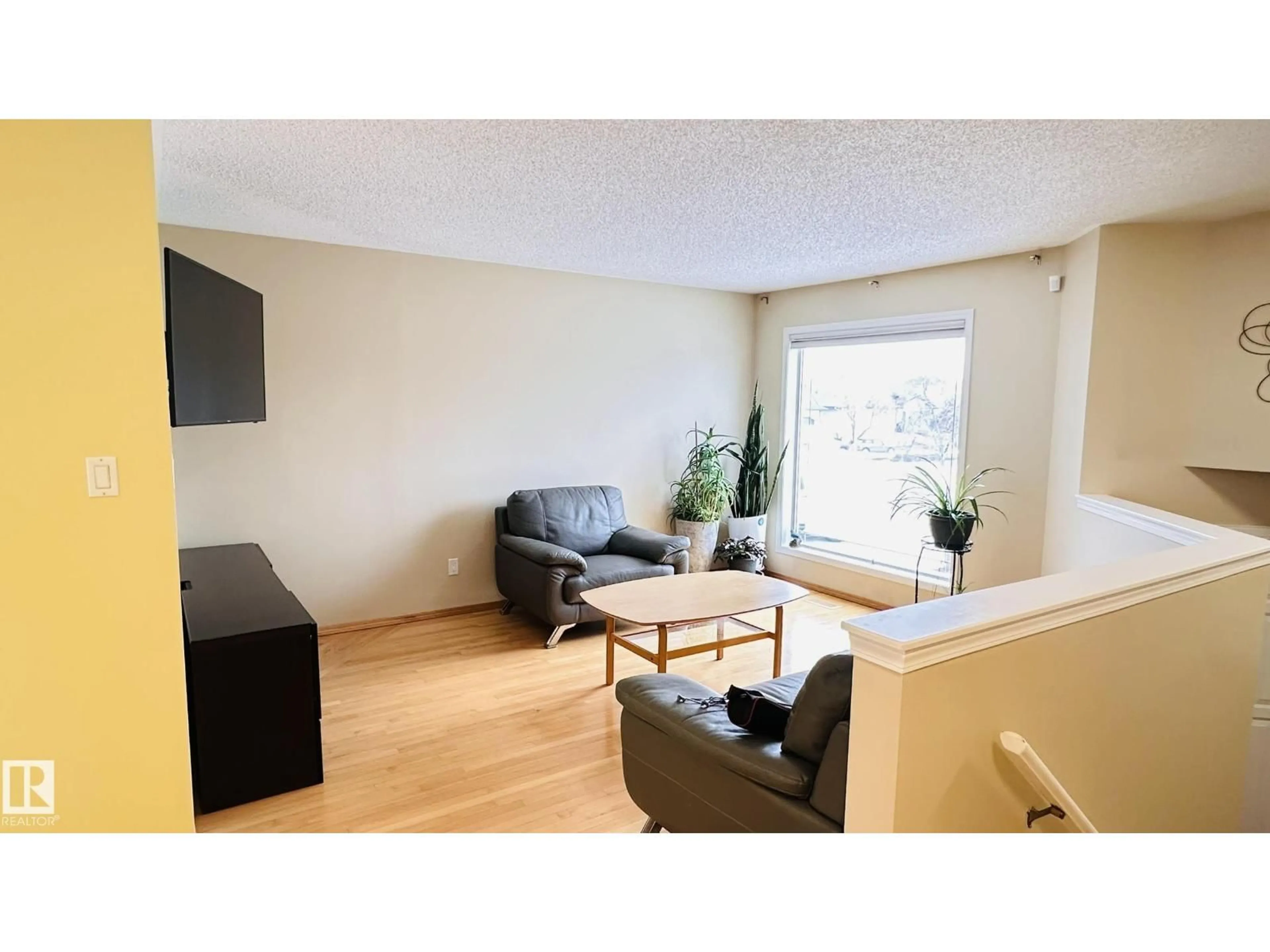 Living room with furniture, wood/laminate floor for 3912 30 ST, Edmonton Alberta T6T1K4