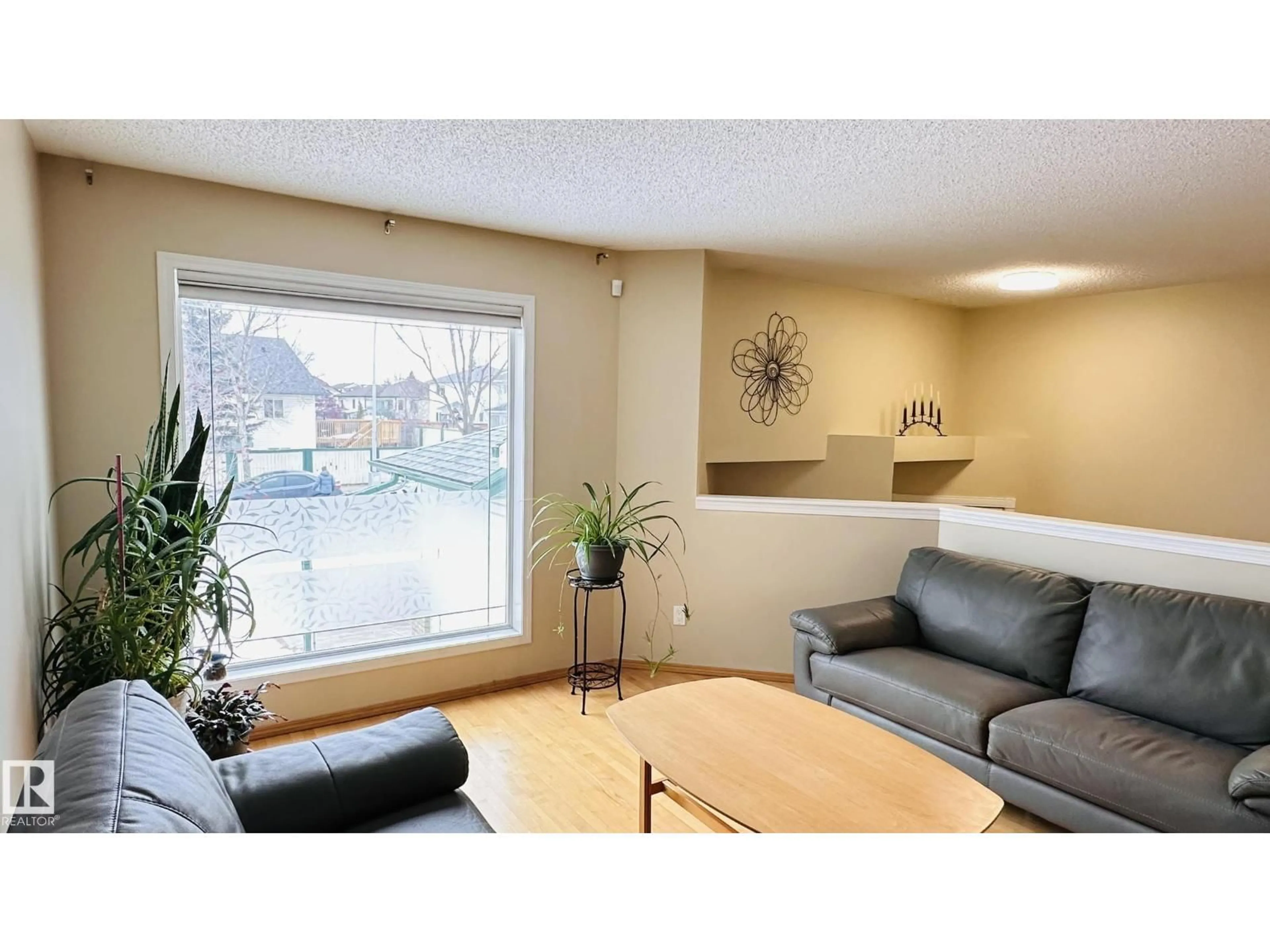 Living room with furniture, wood/laminate floor for 3912 30 ST, Edmonton Alberta T6T1K4